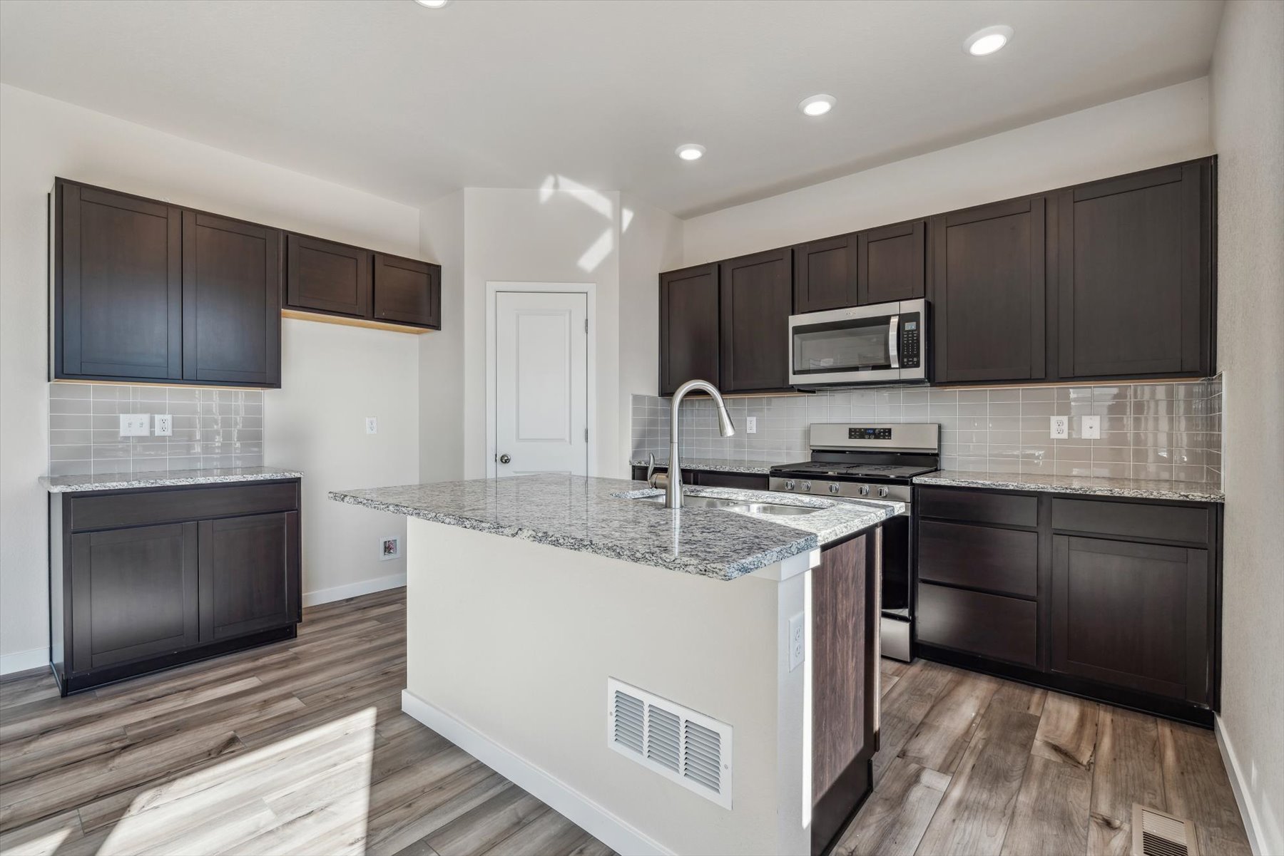 A kitchen with black cabinets.