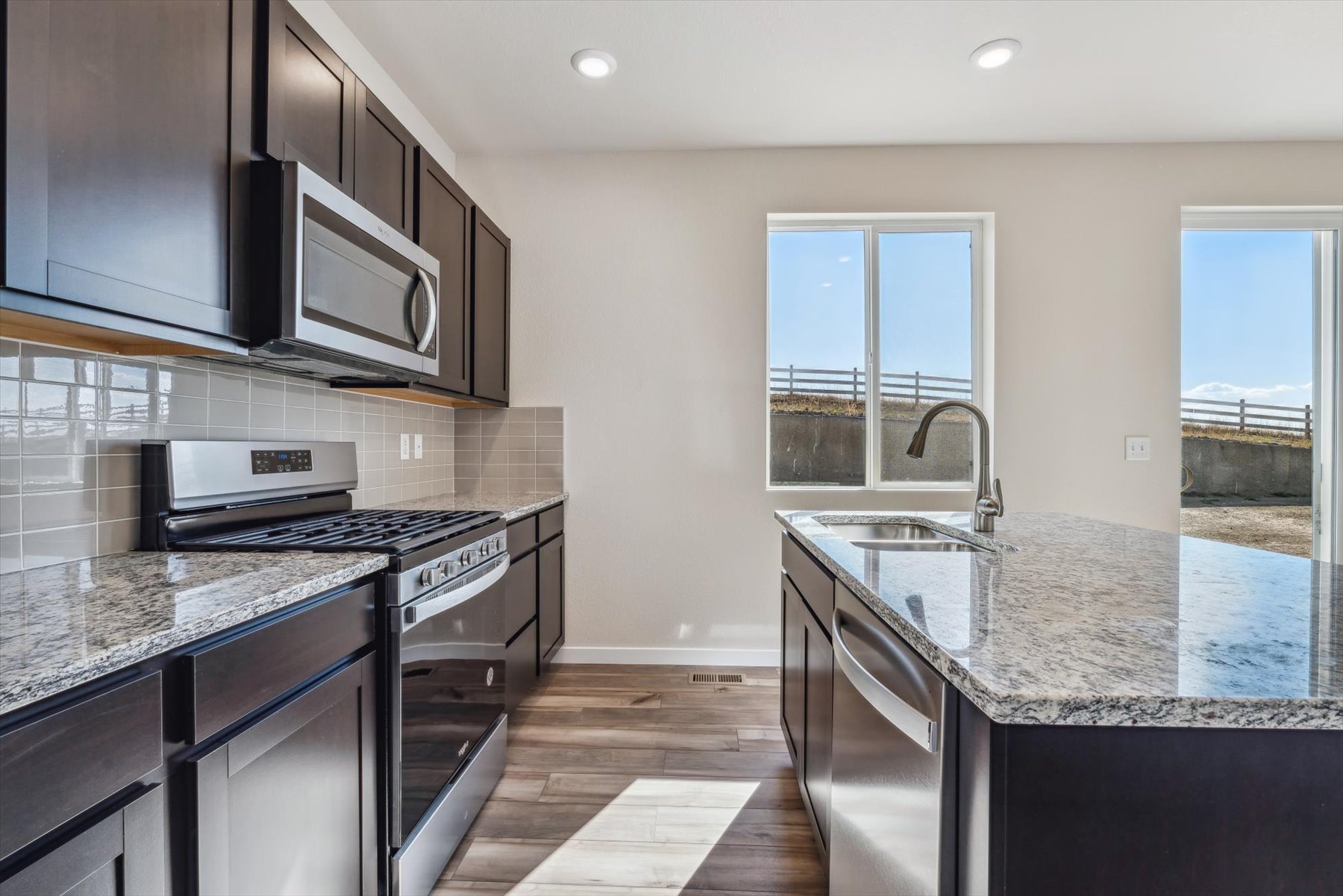 A kitchen with black cabinets.