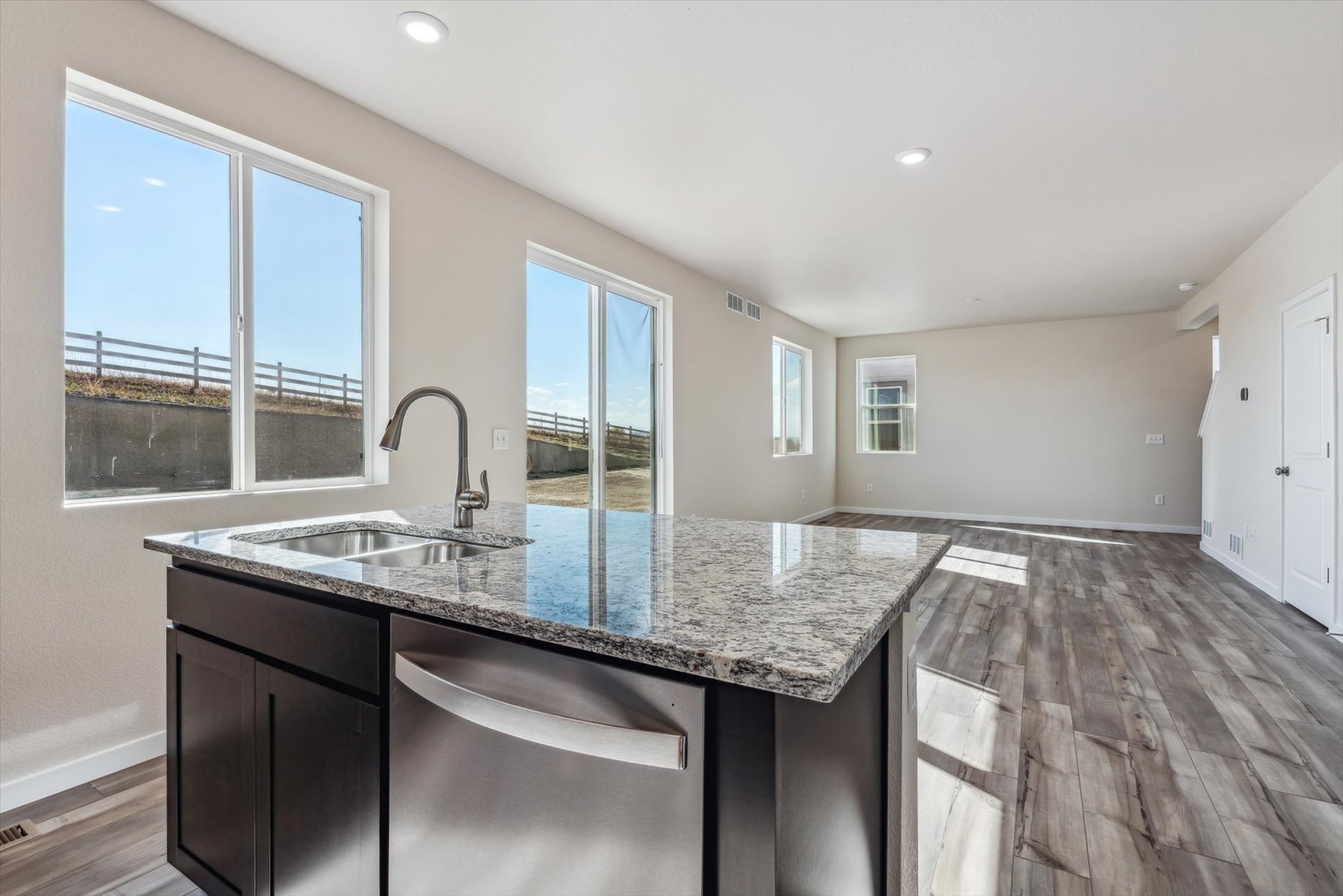 A kitchen with a marble counter top.