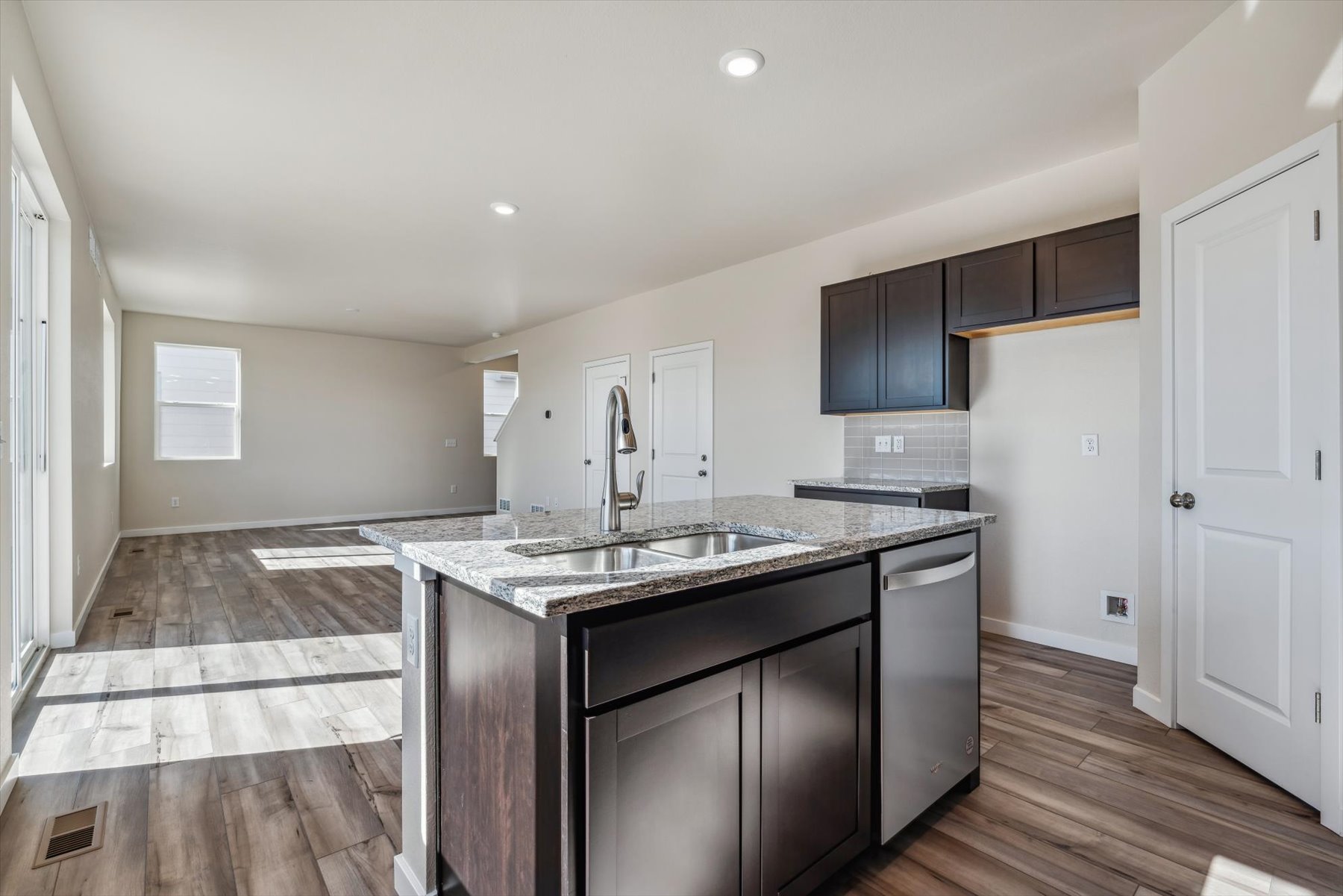 A kitchen with black cabinets.