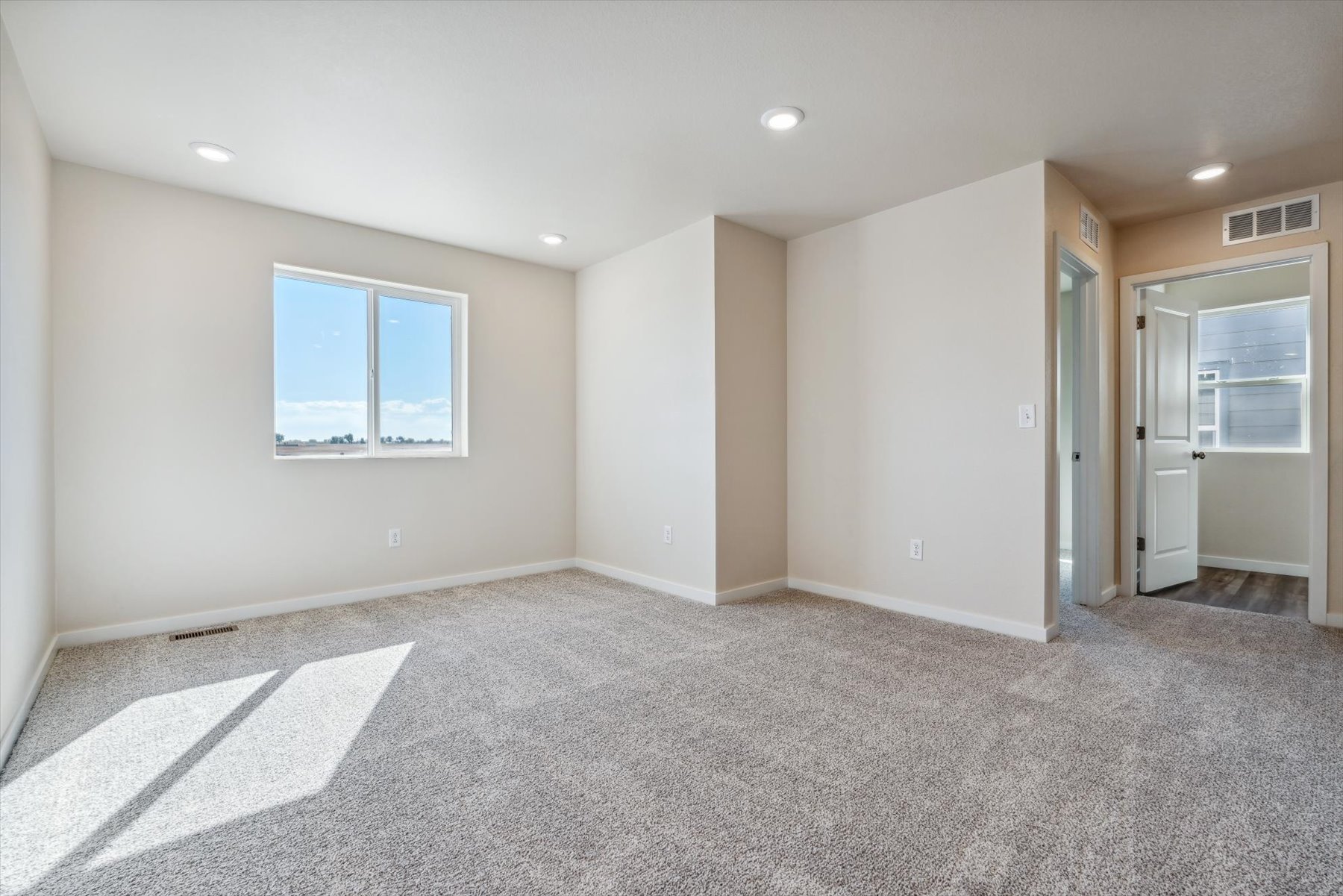 A room with a carpet and a rug.
