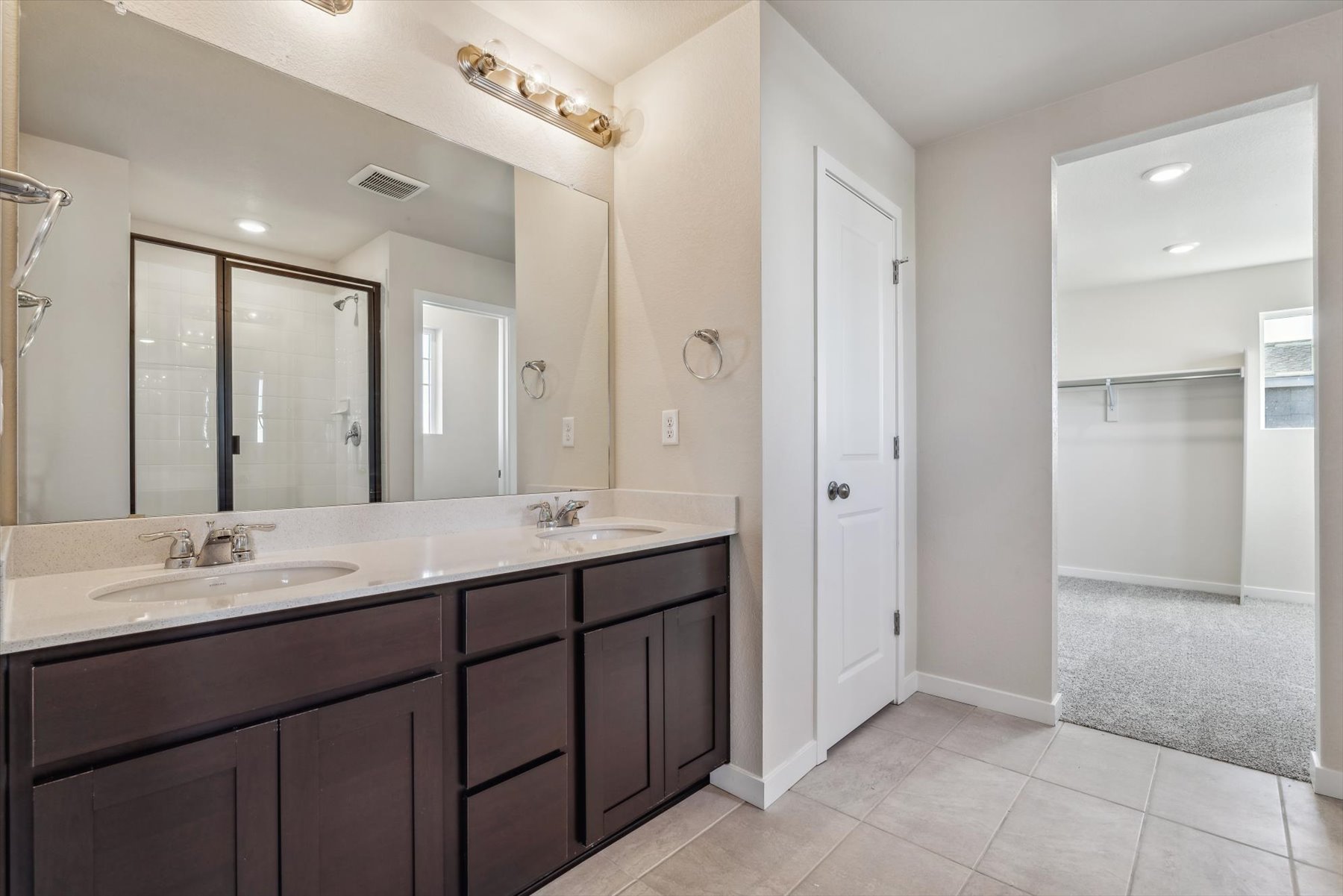 A bathroom with a large mirror.