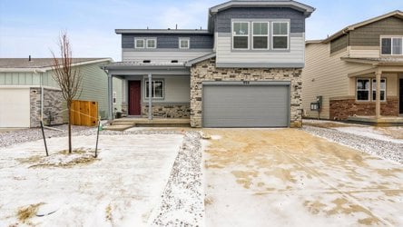 A house with a garage and a fence in the front.