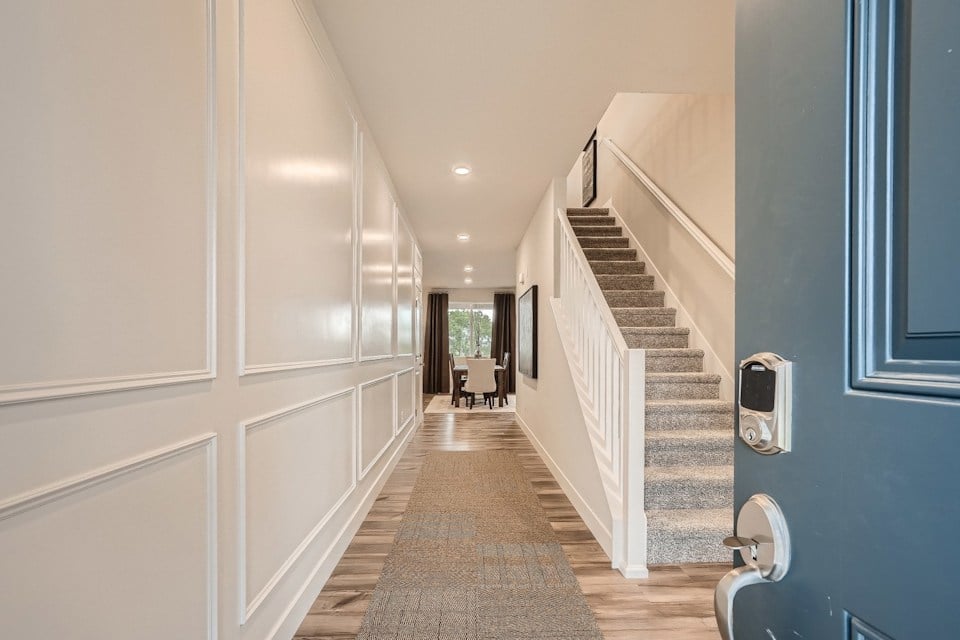 A hallway with a staircase.