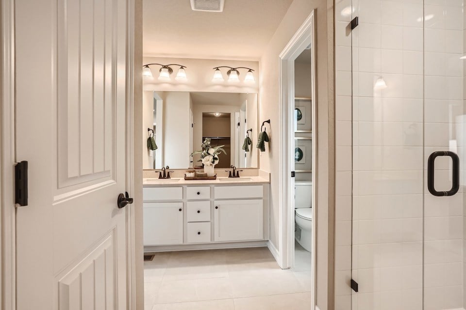 A bathroom with a shower and sink.