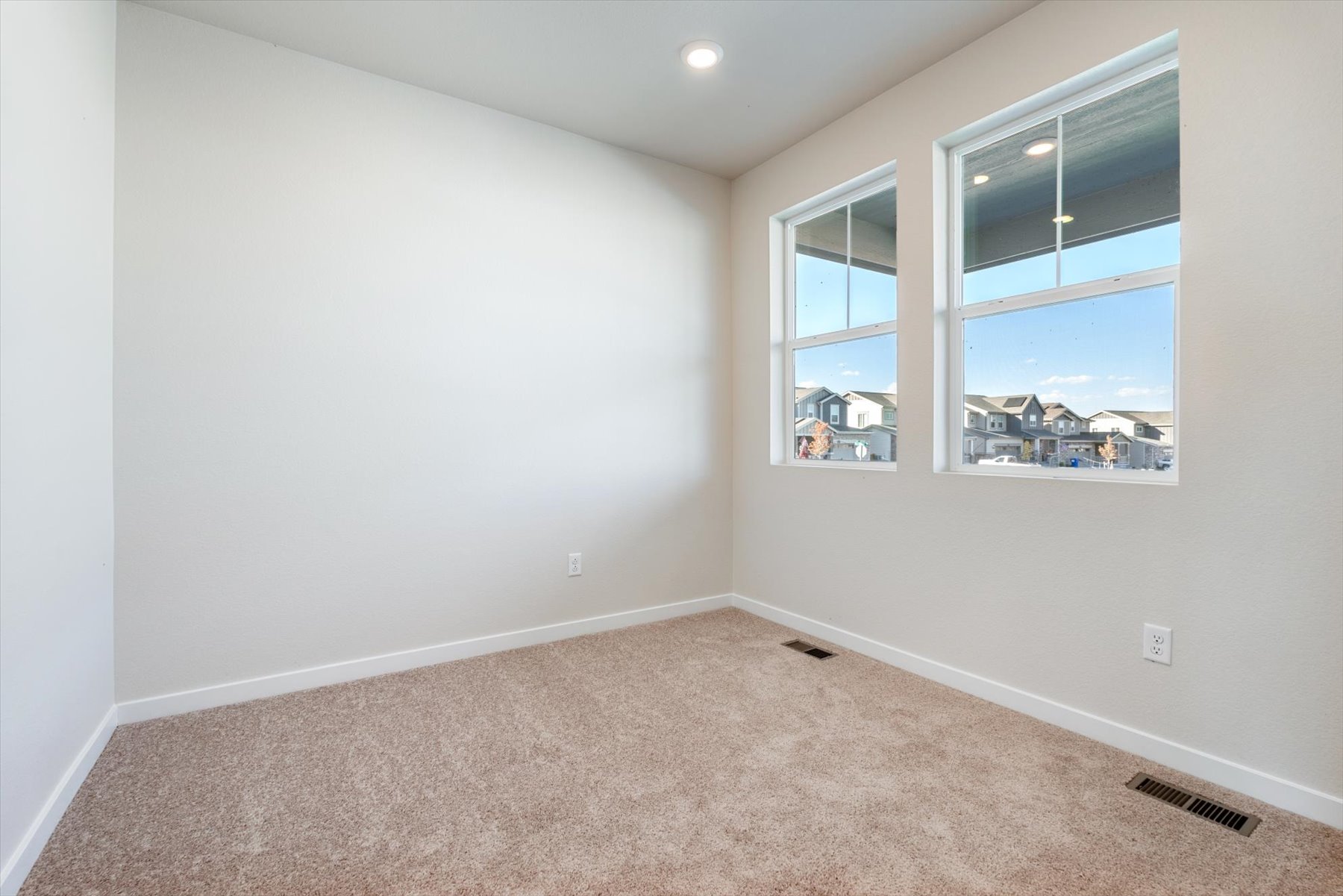 A room with a window and a carpet.