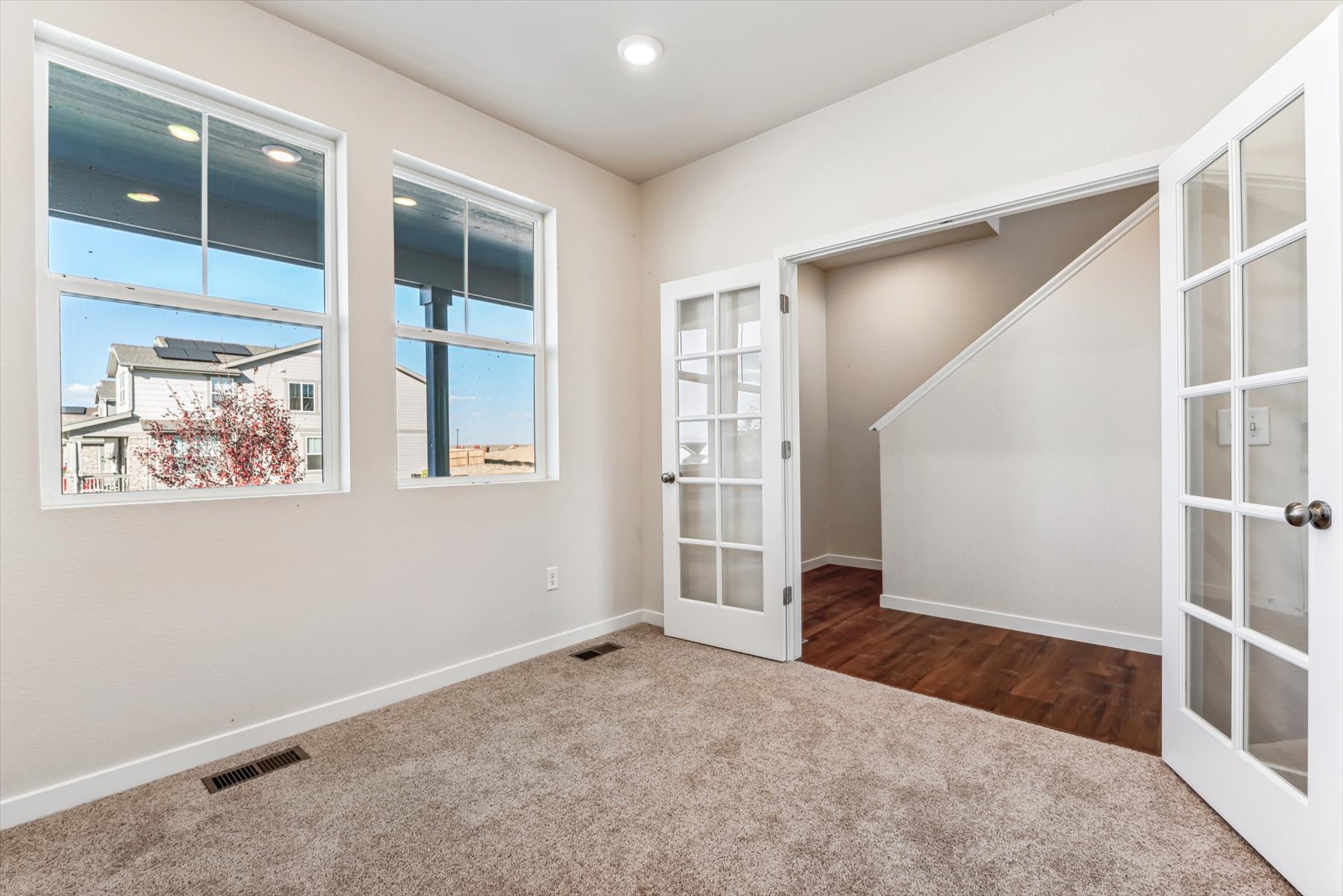 A room with a window and a door with a glass door.