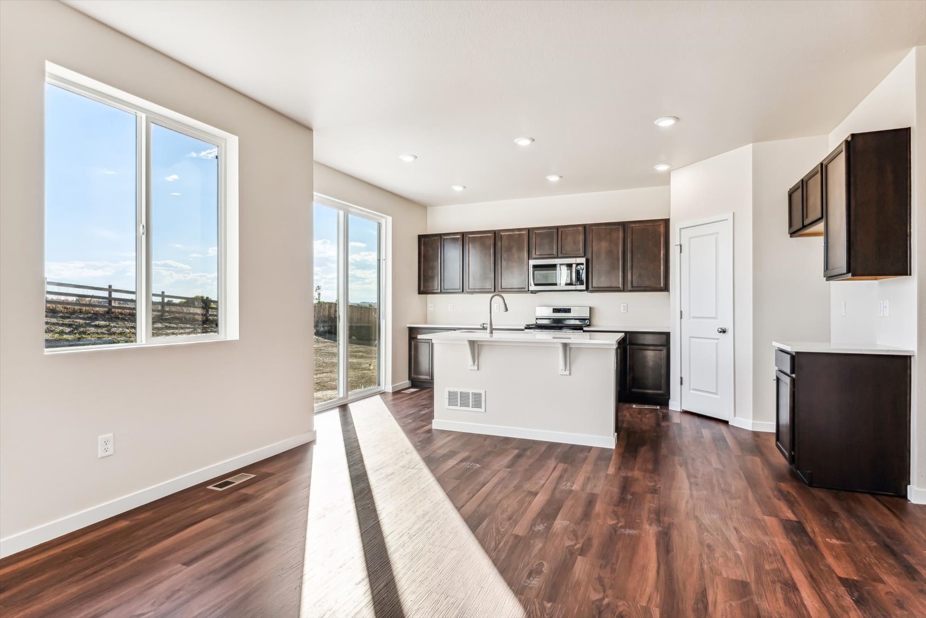 A kitchen with a wood floor.