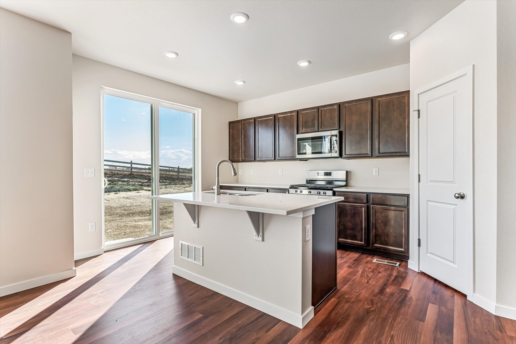 A kitchen with a large glass door.