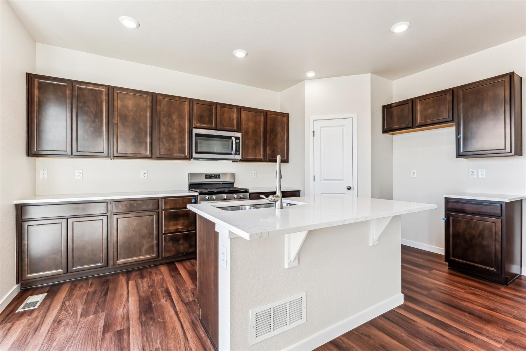 A kitchen with wooden cabinets.