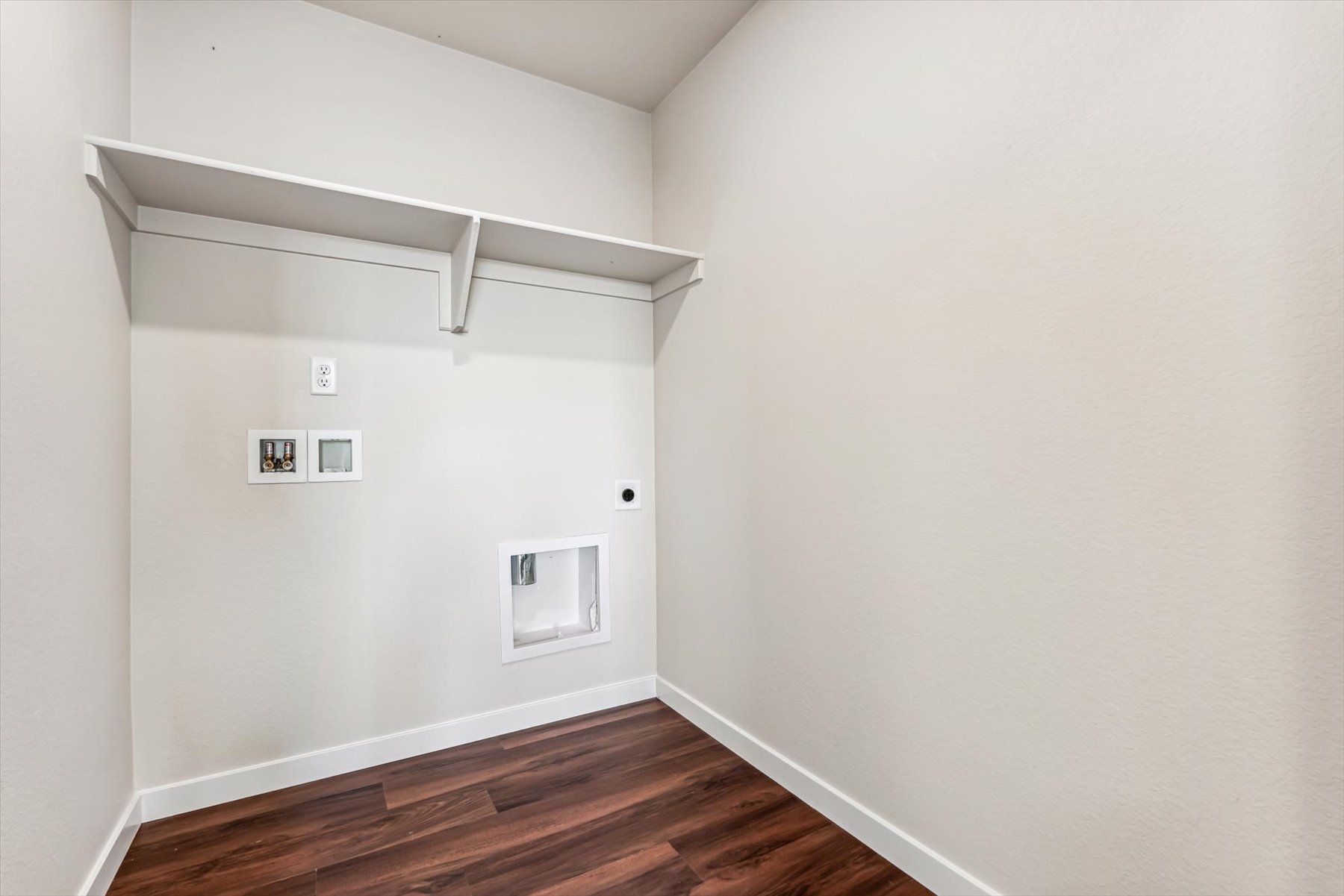 A white room with a wood floor.