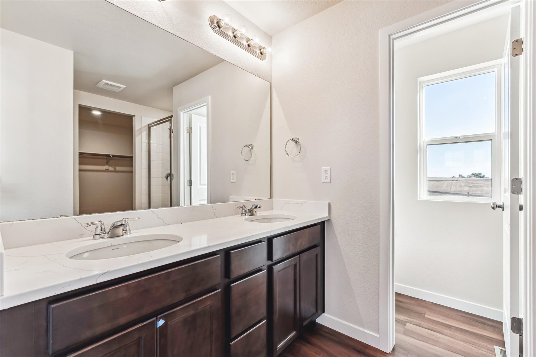 A bathroom with a large mirror.