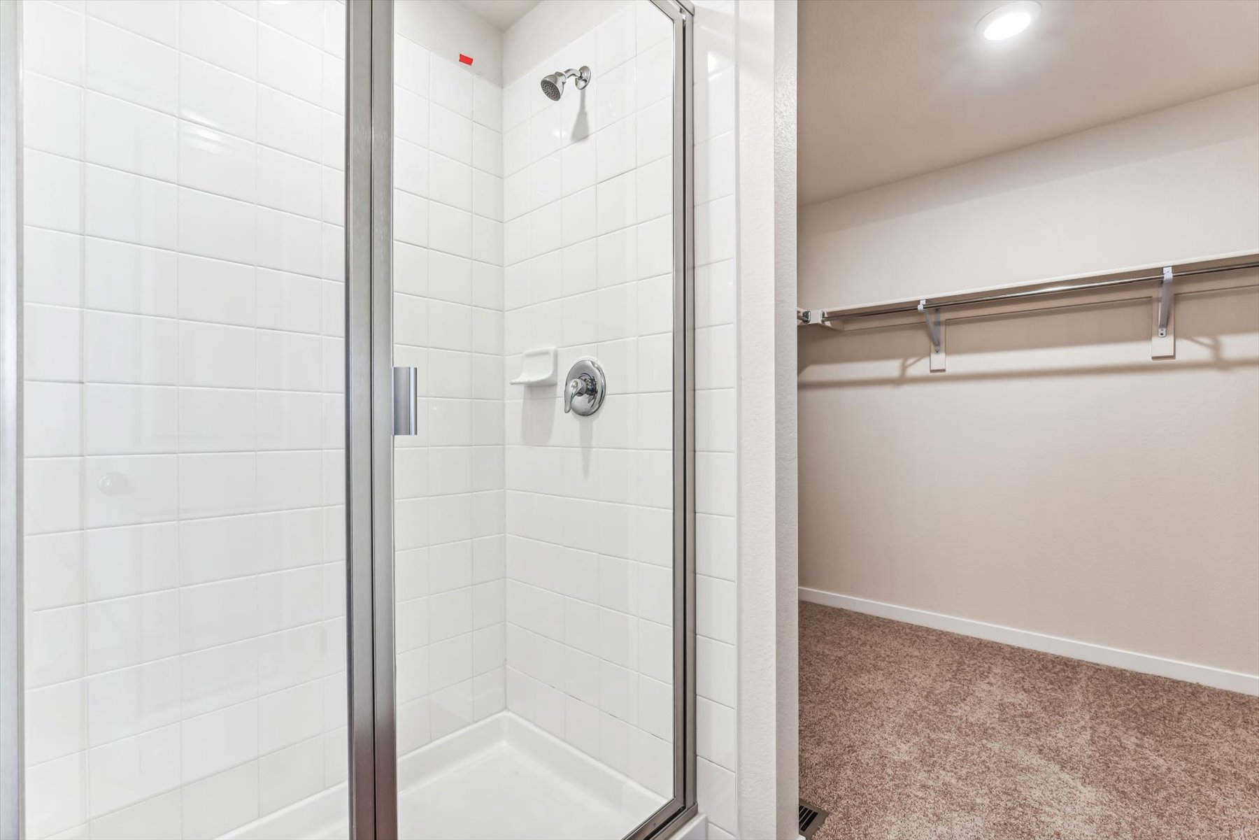 A shower with a glass door.