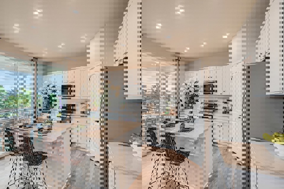 A kitchen with white cabinets.