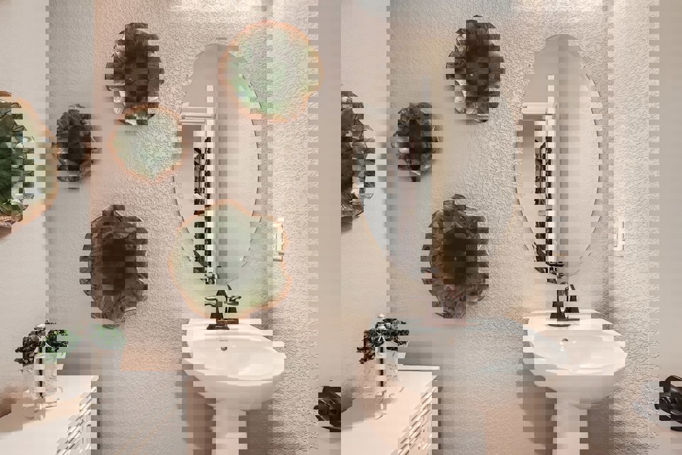 A bathroom with a mirror and a sink.