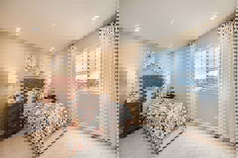 A bedroom with a large window.