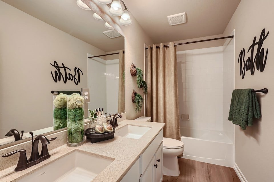 A bathroom with a sink toilet and bathtub.