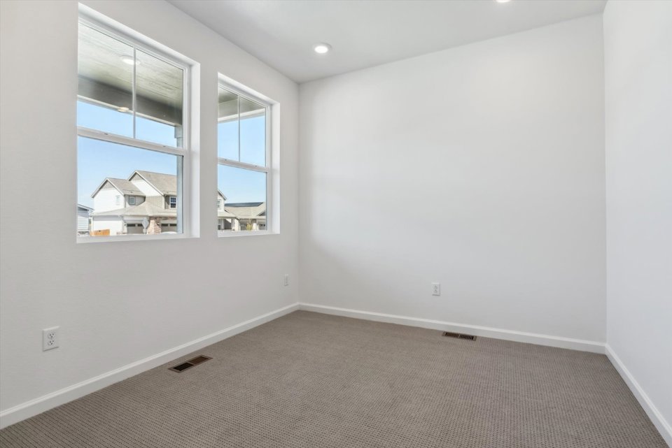 A room with a window and a carpet.