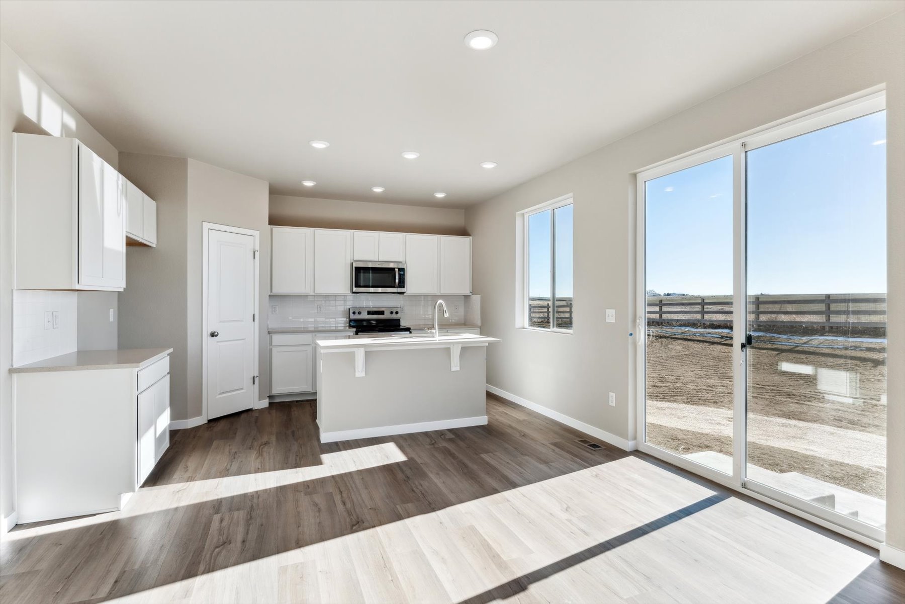 A kitchen with white cabinets.