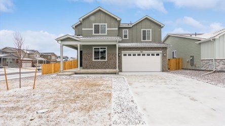 A house with a garage and a fence around it.