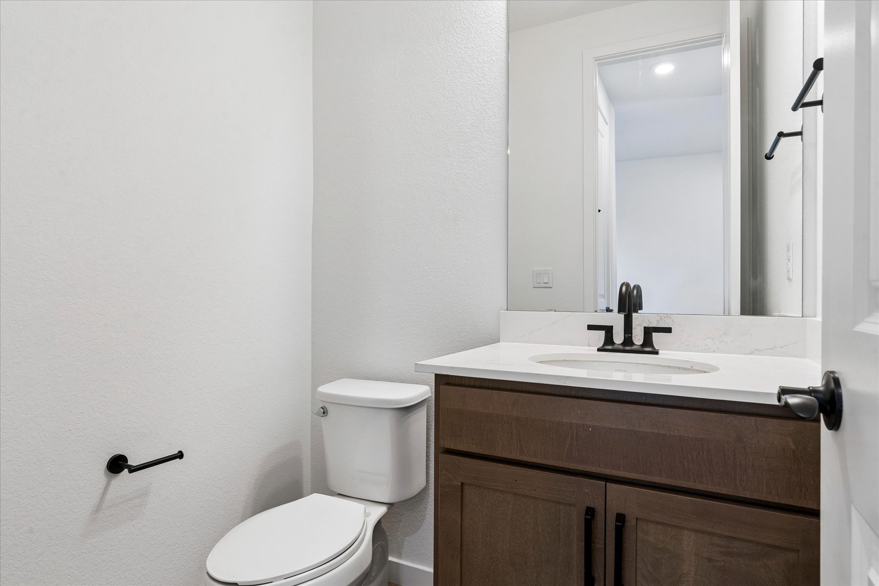 A bathroom with a toilet and sink.