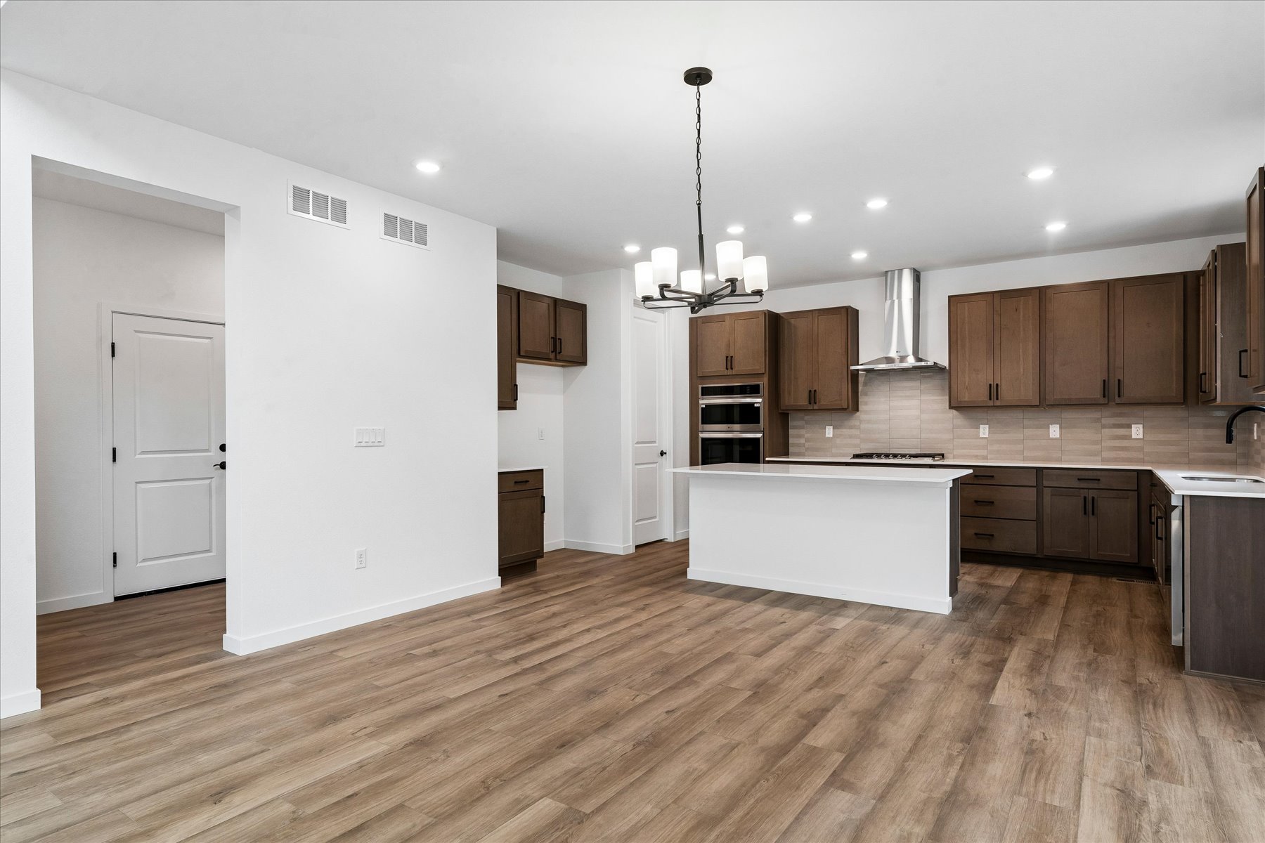 A kitchen with wooden floors.
