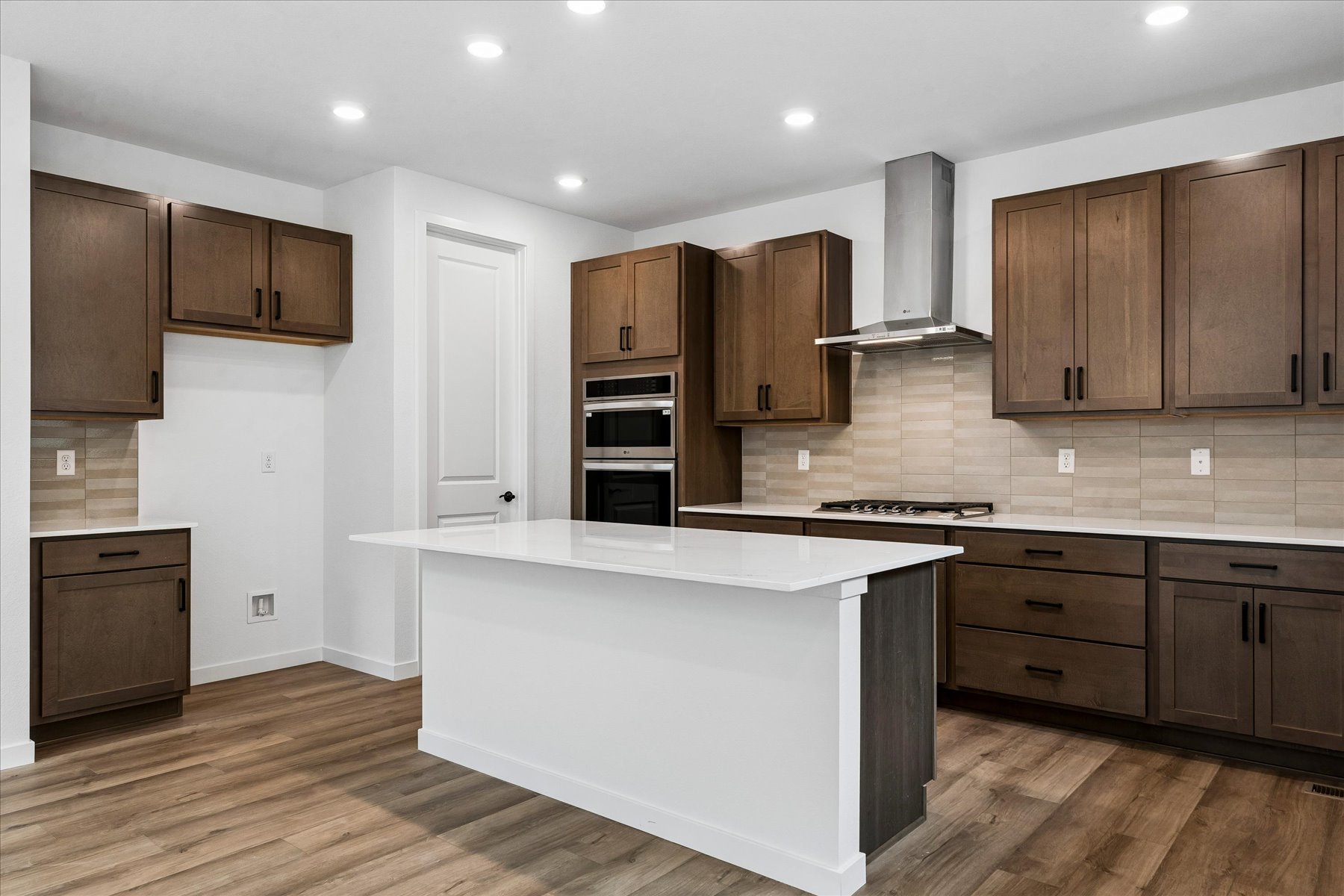 A kitchen with wooden cabinets.