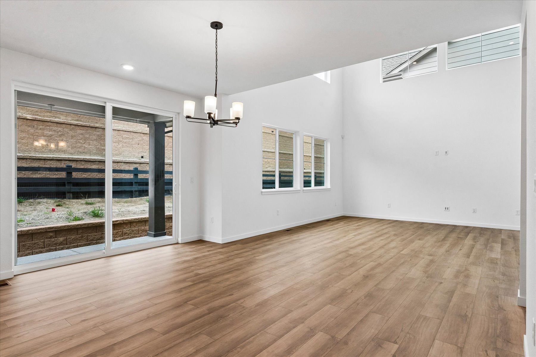 A room with a wood floor and a window with a wood floor.