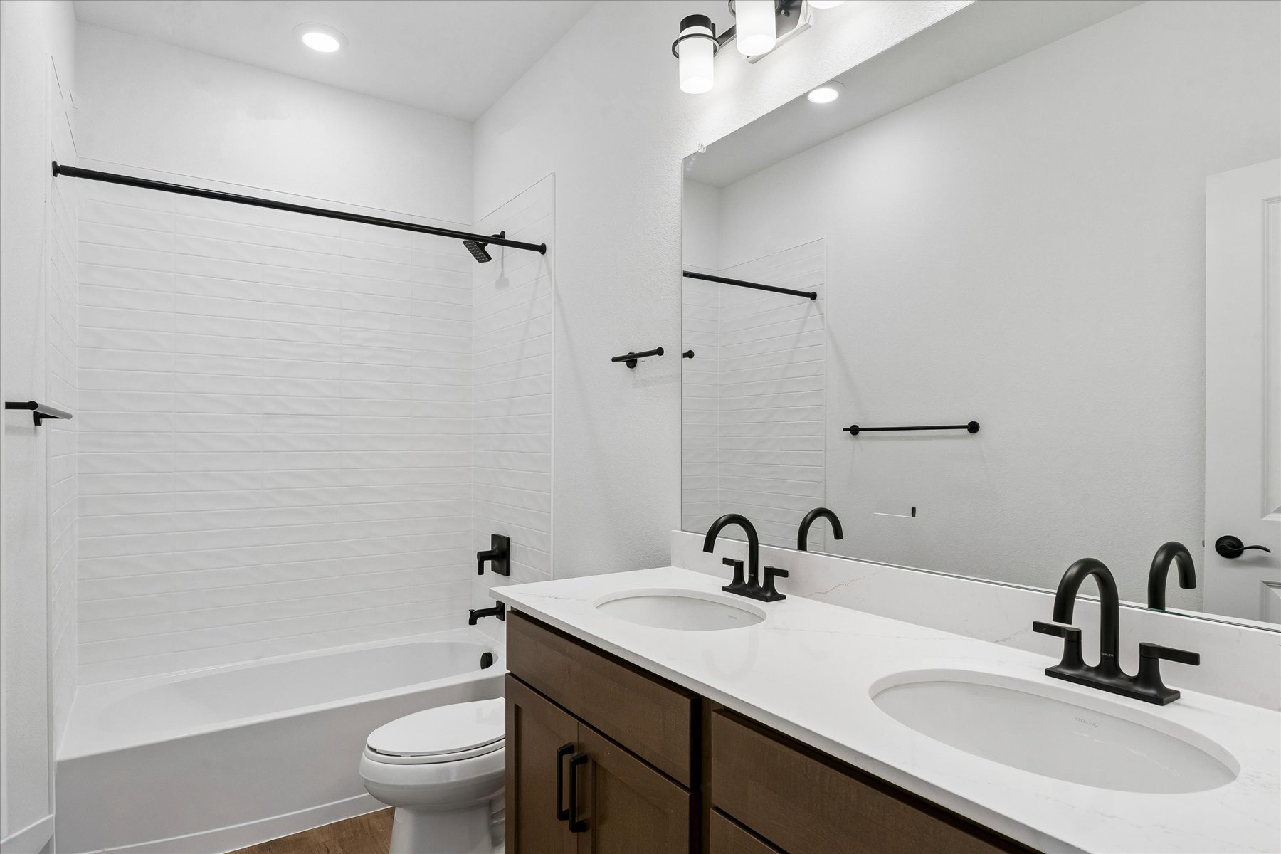 A bathroom with a sink toilet and bathtub.