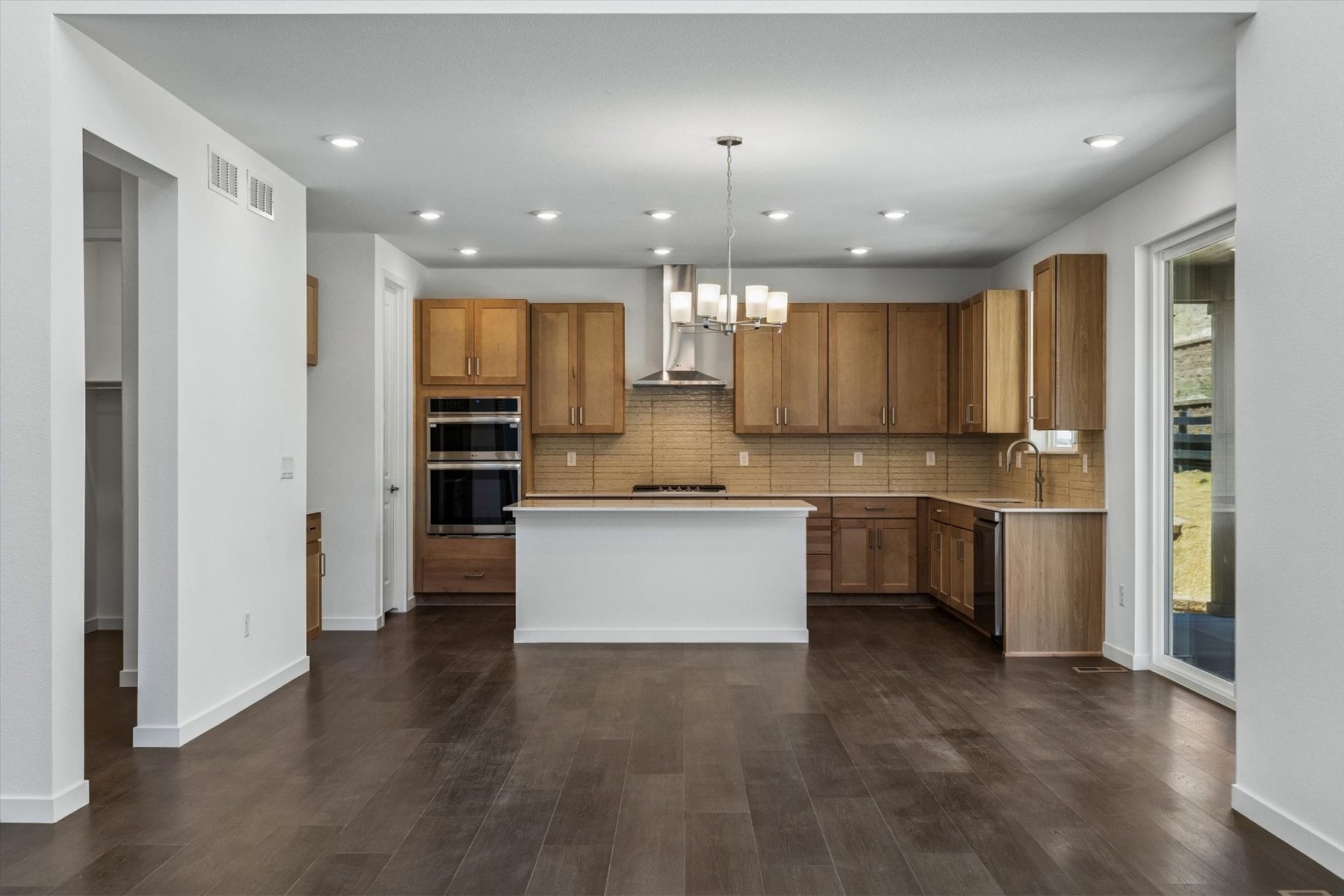 A kitchen with wooden cabinets.