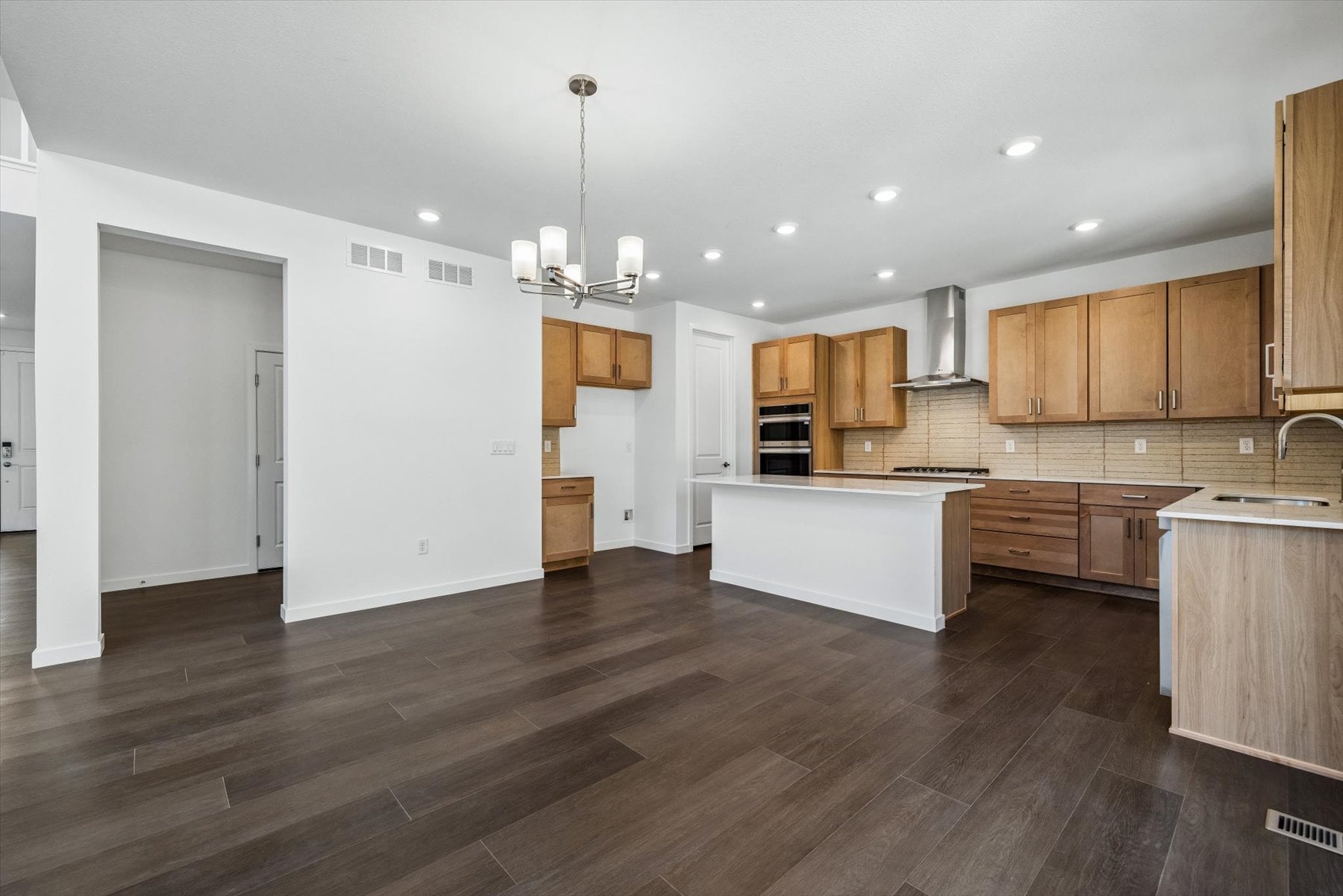 A kitchen with wooden cabinets.