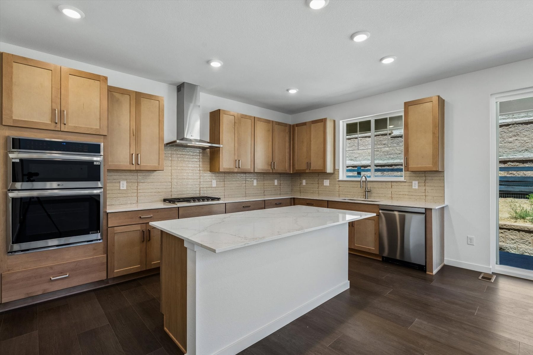 A kitchen with wooden cabinets.