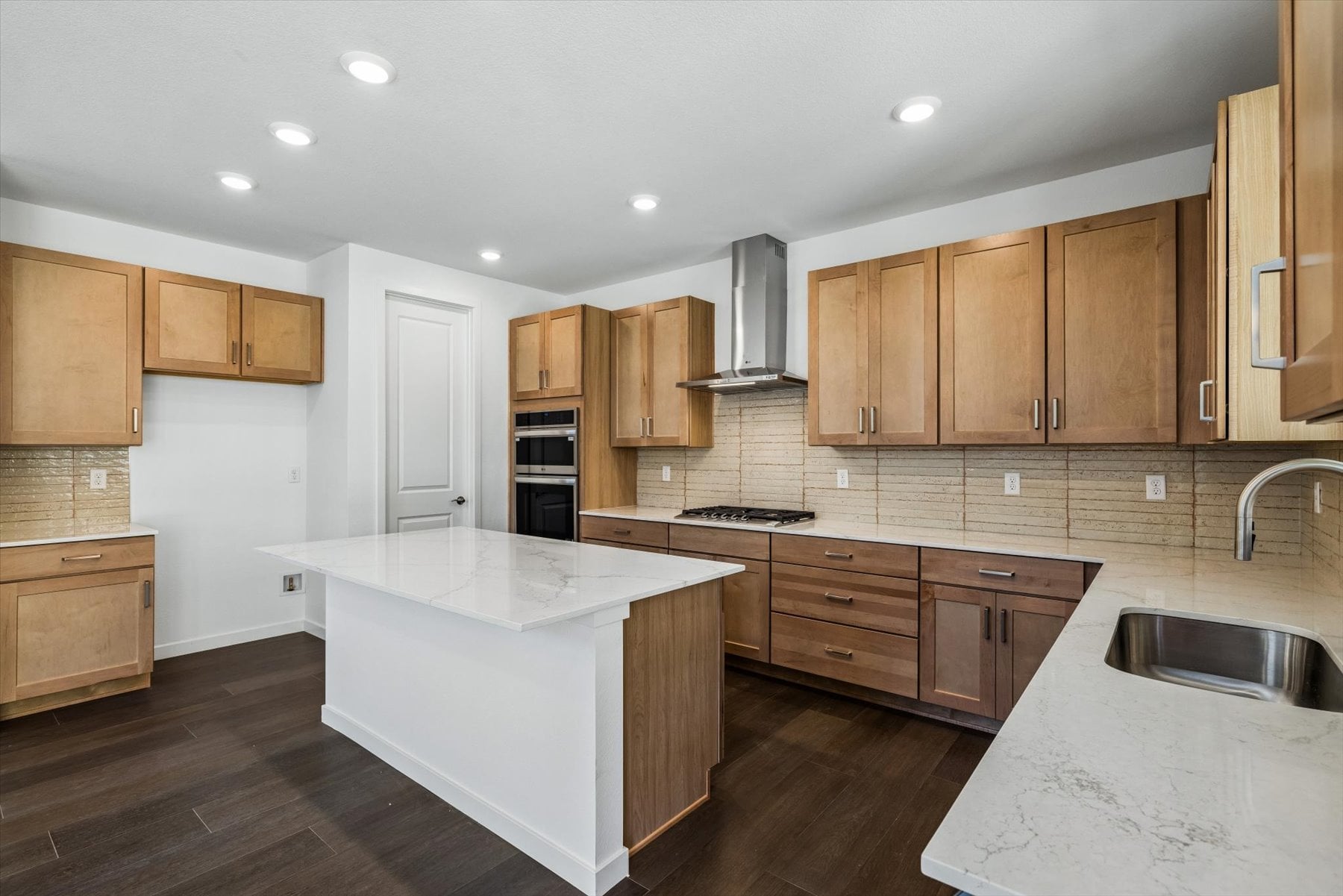 A kitchen with wooden cabinets.