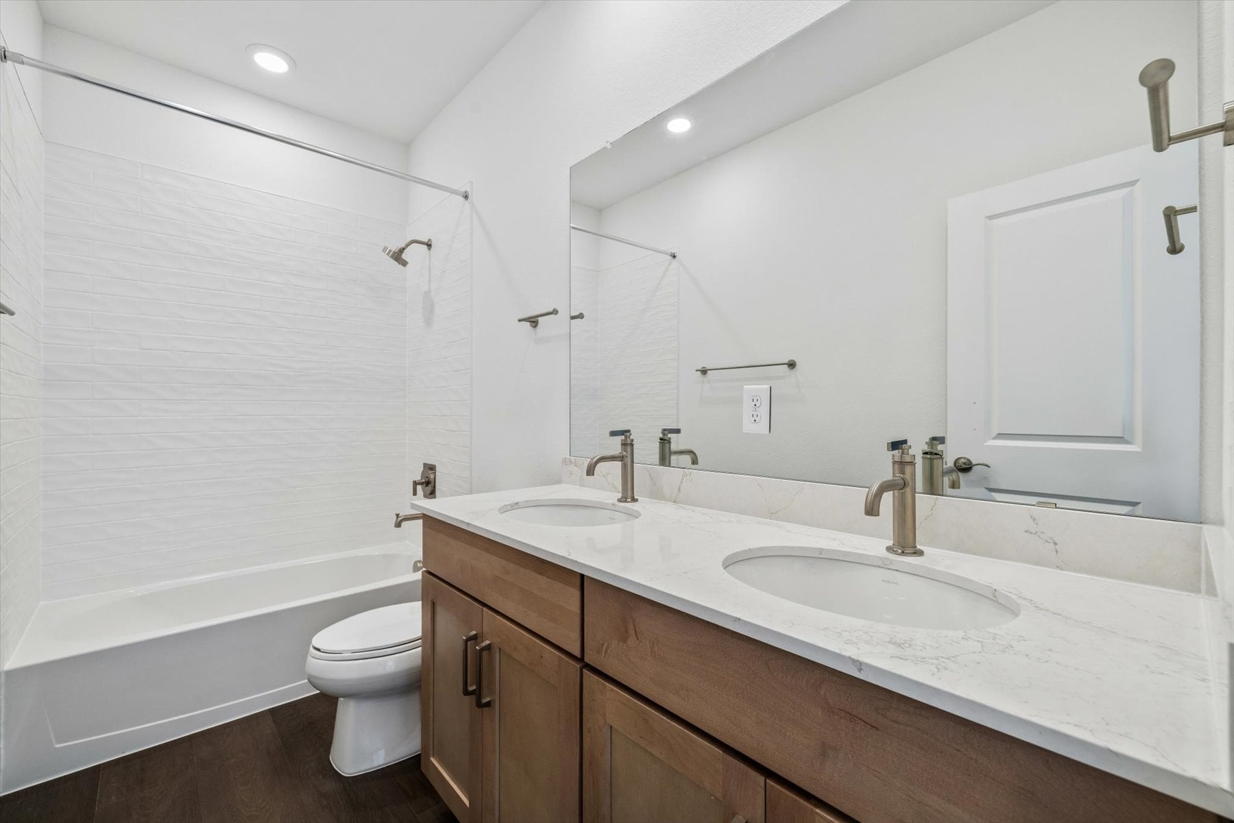 A bathroom with a tub sink and toilet.