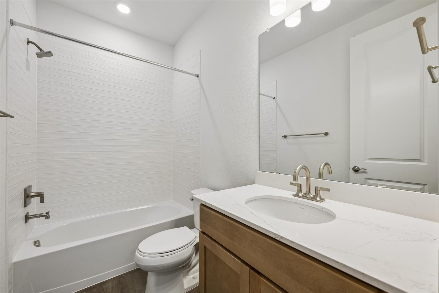 A bathroom with a tub sink and toilet.