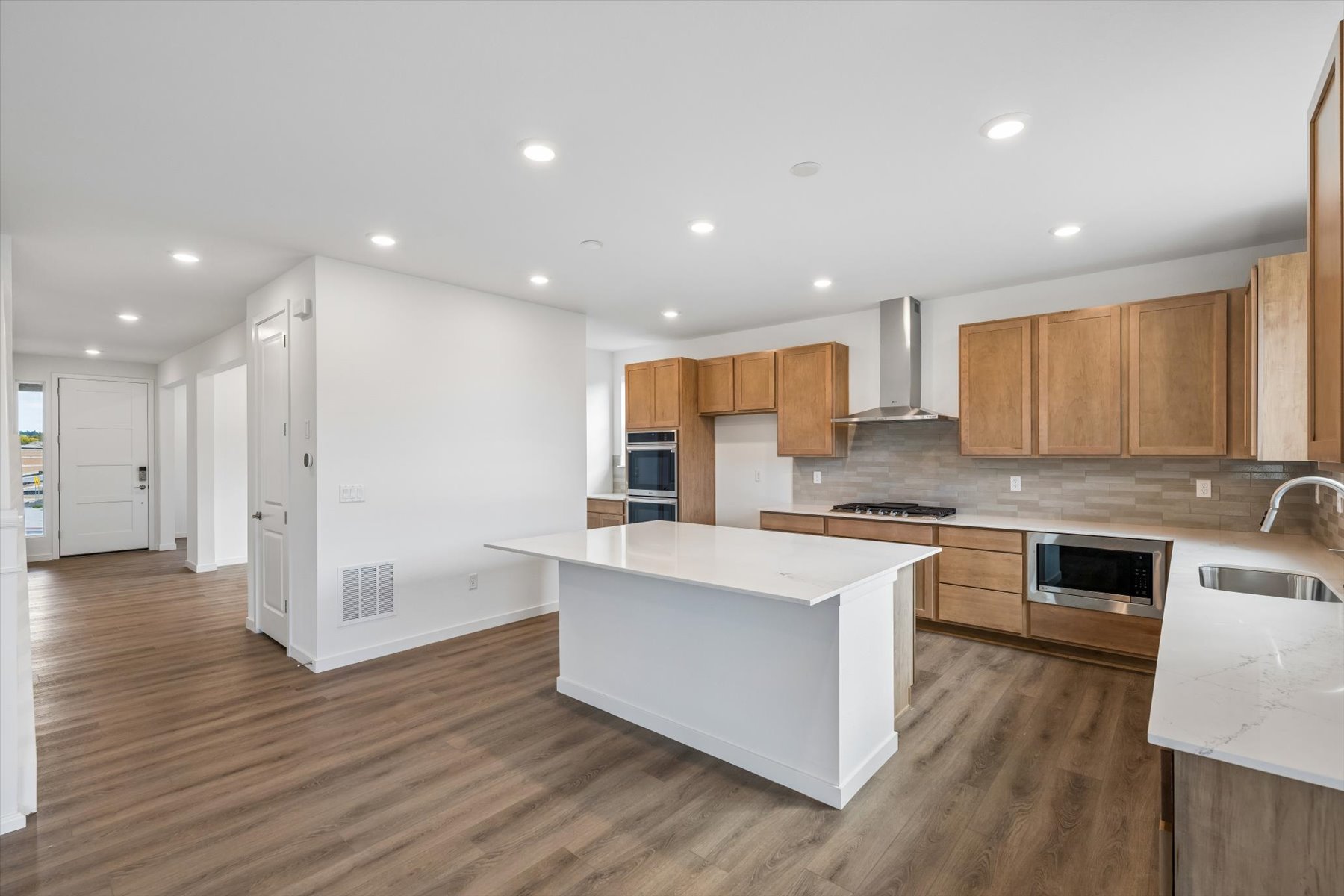 A kitchen with wooden cabinets.
