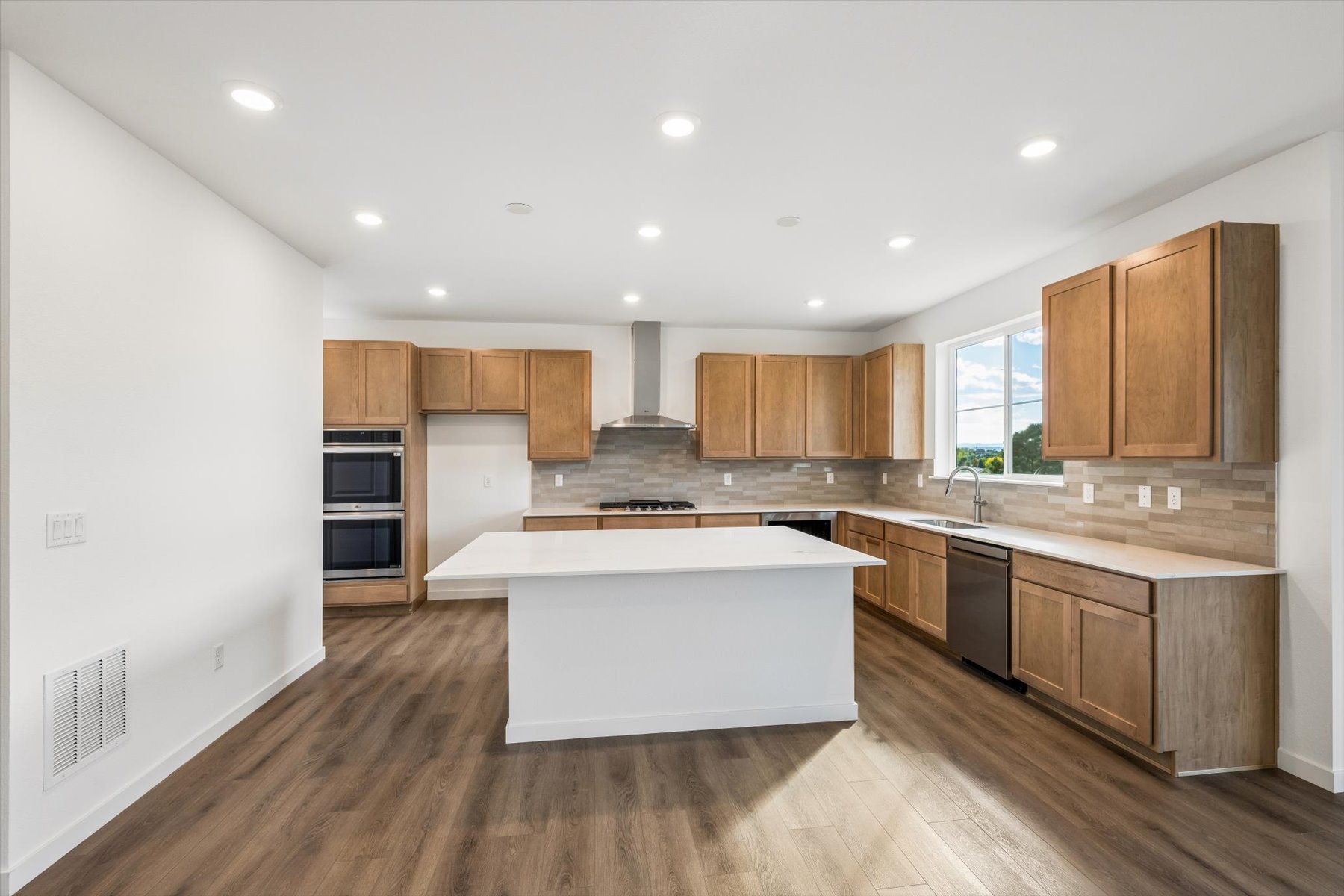 A kitchen with wooden cabinets.