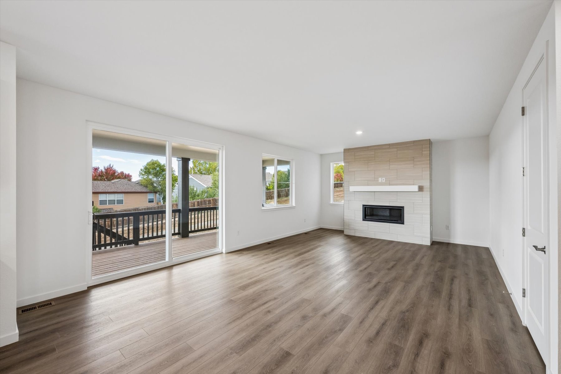 A large living room with a wood floor.