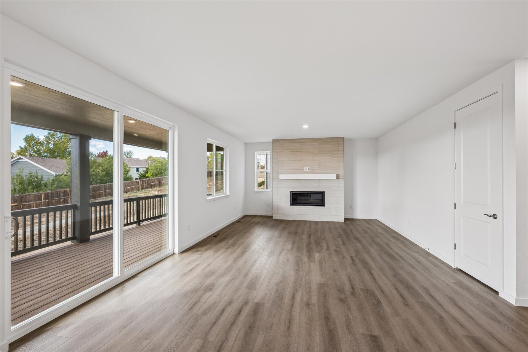 A room with a wood floor and a fireplace.
