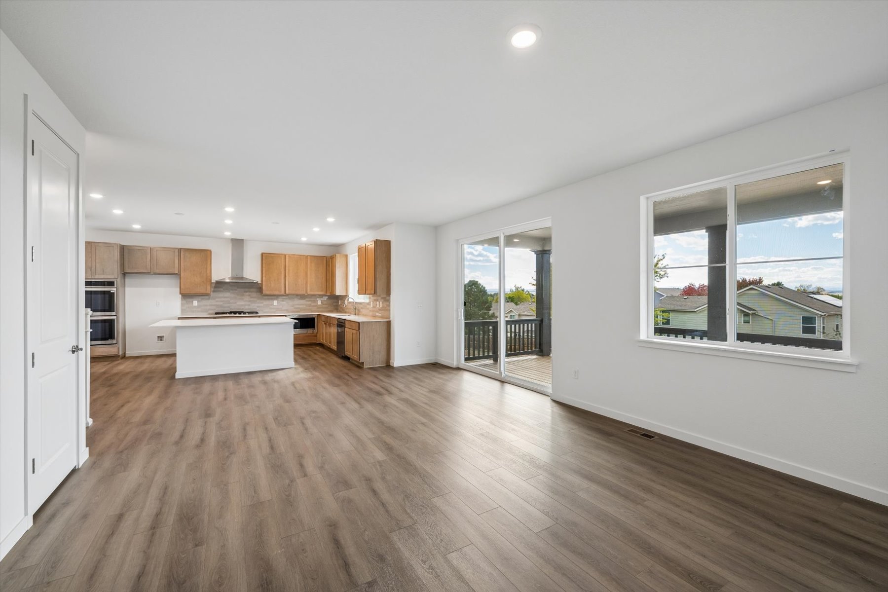 A large kitchen with a wood floor.