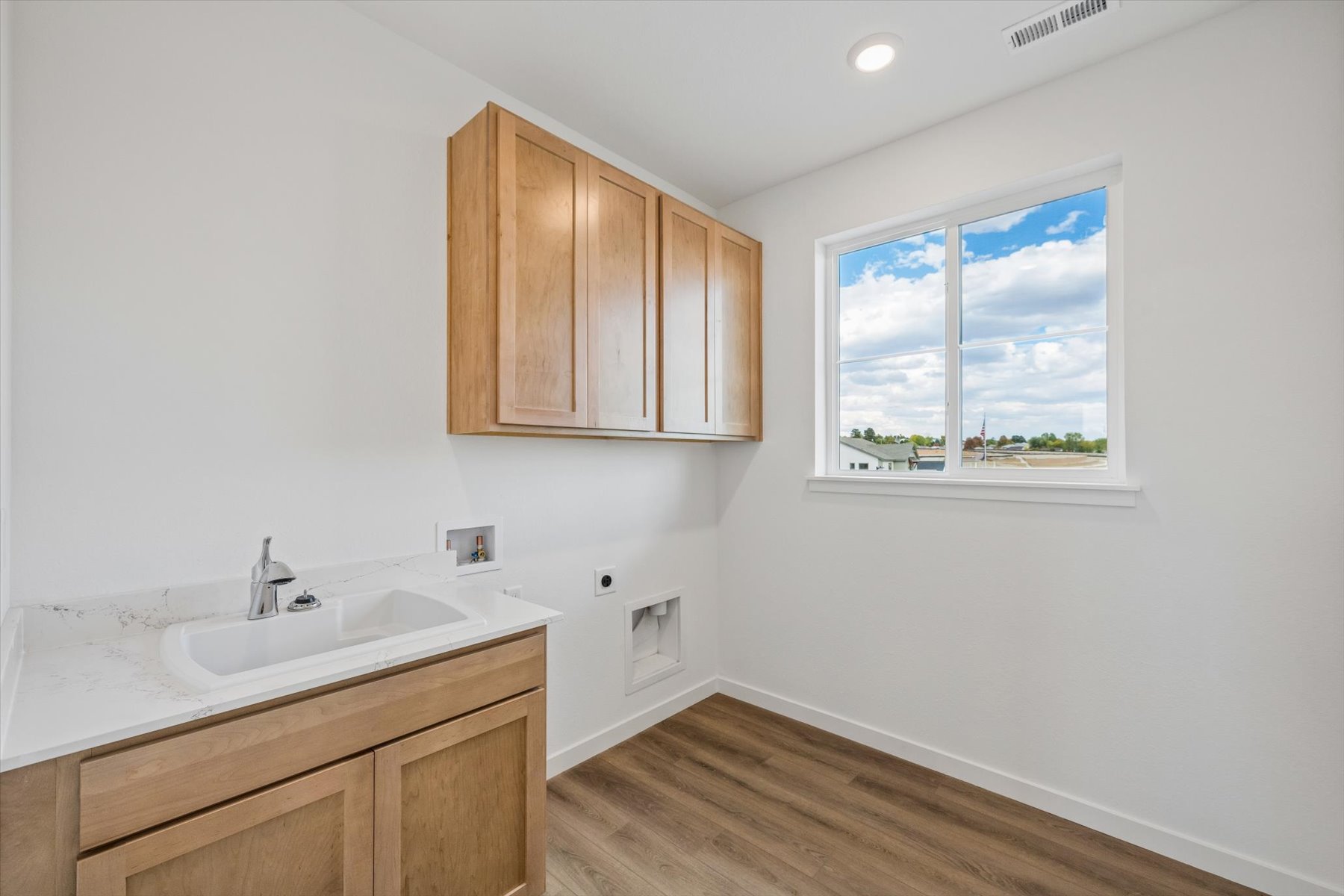 A bathroom with a sink and a window.