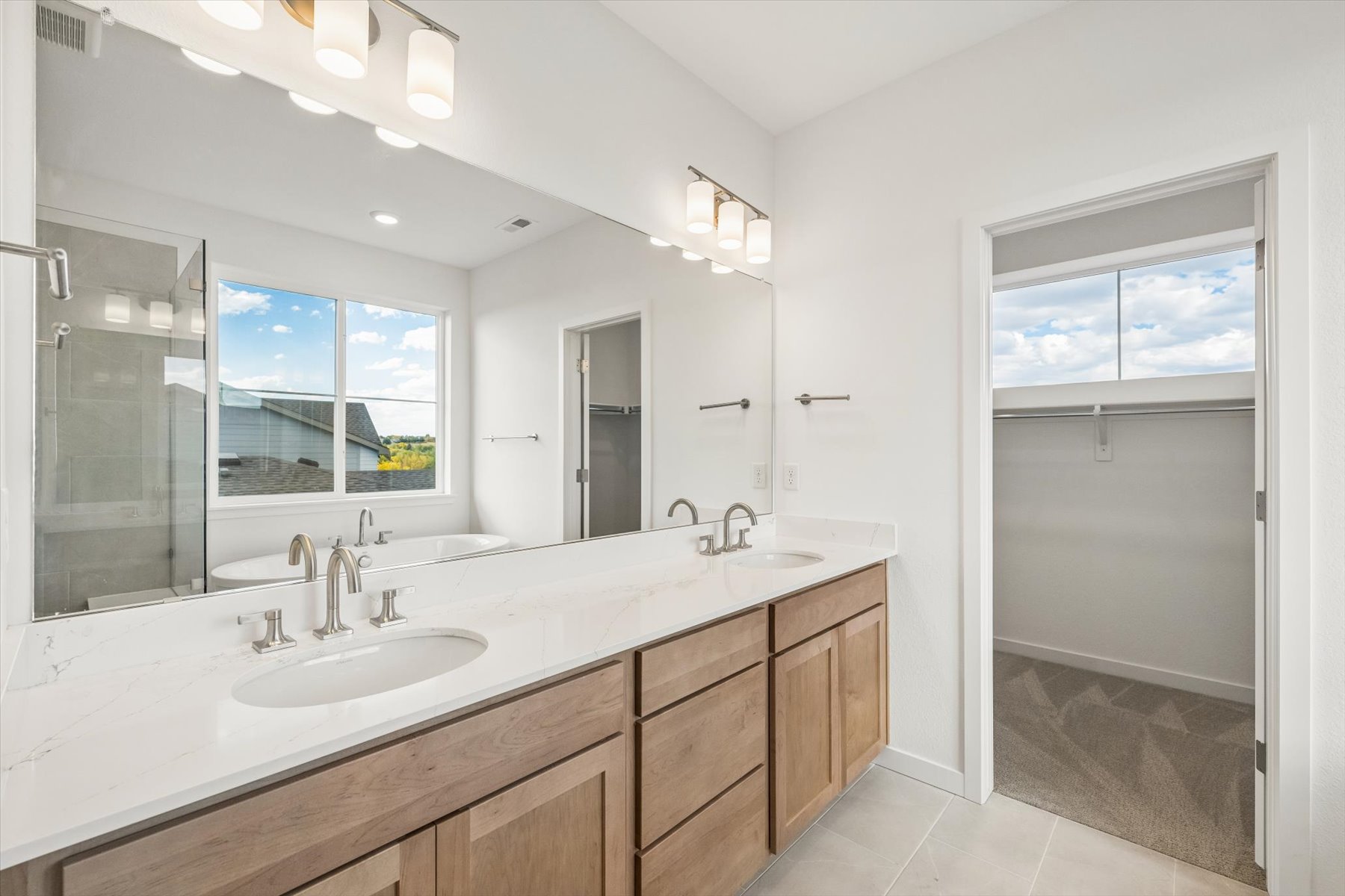 A bathroom with a large mirror.