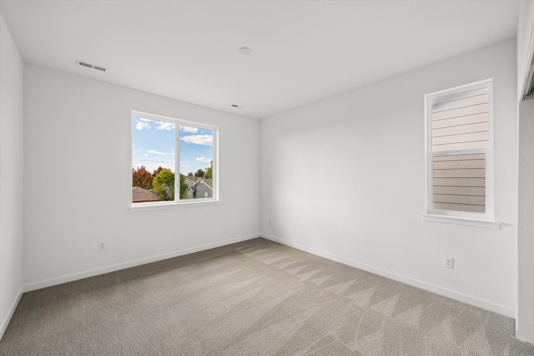 A room with a window and a carpet.