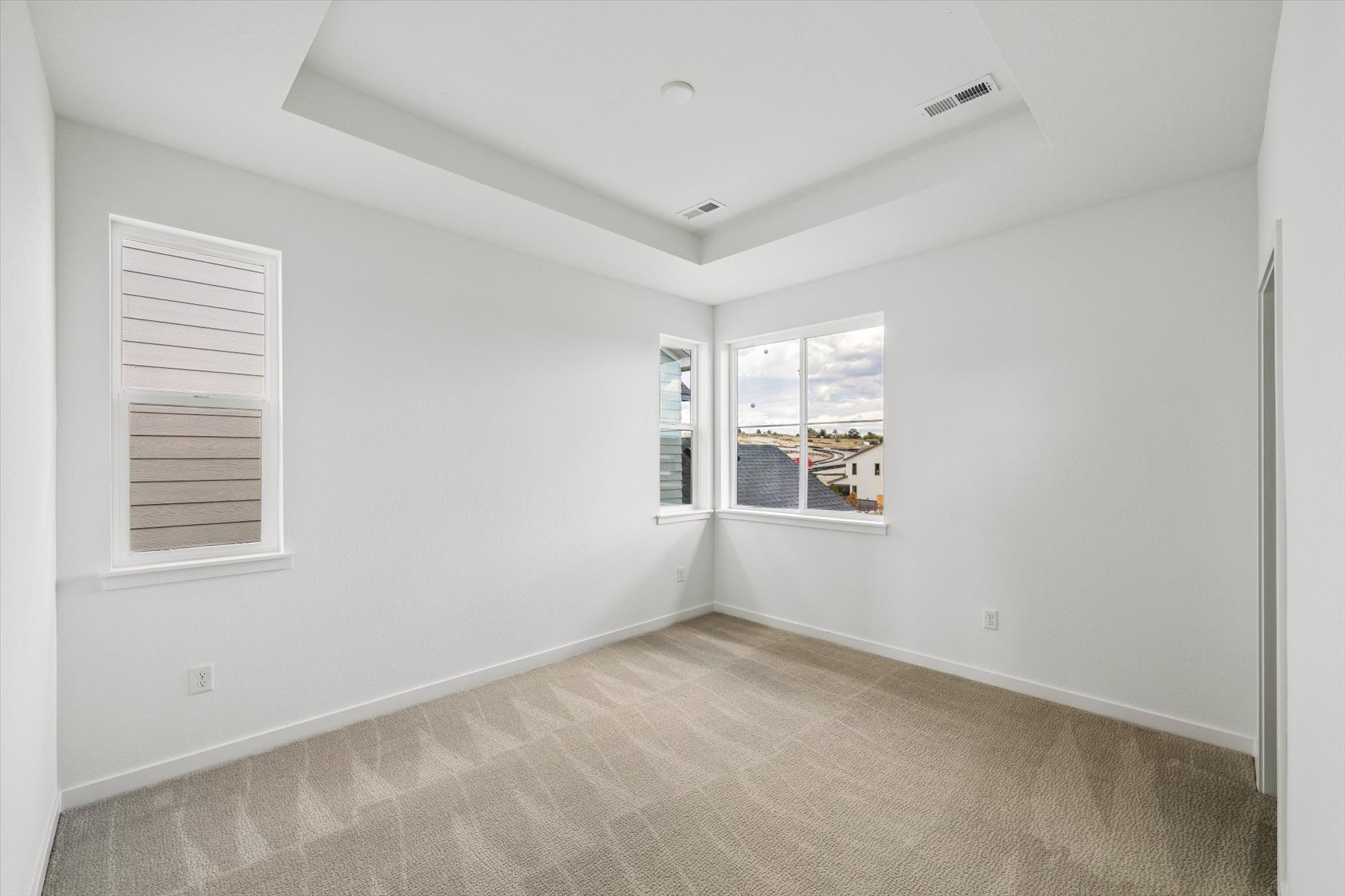 A room with a window and a carpet.