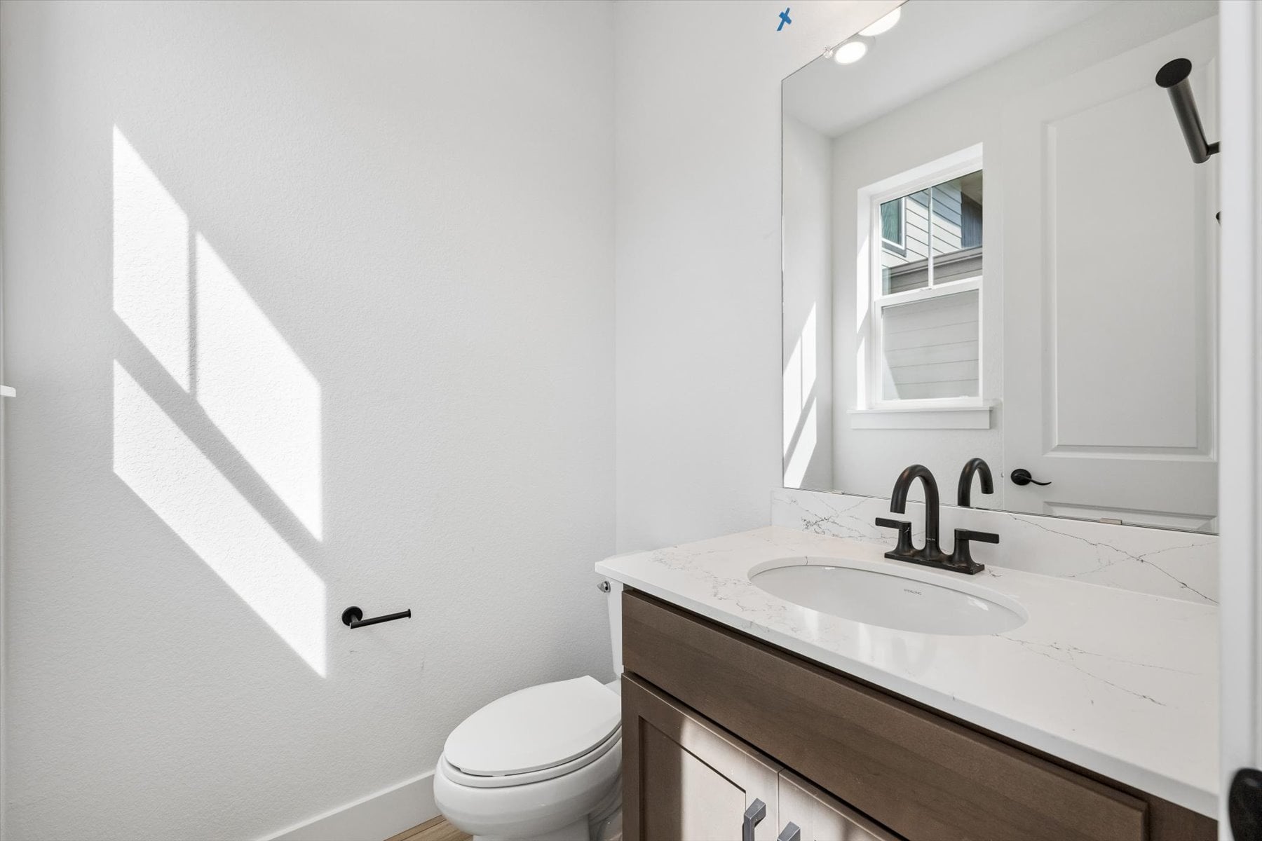A bathroom with a sink and toilet.