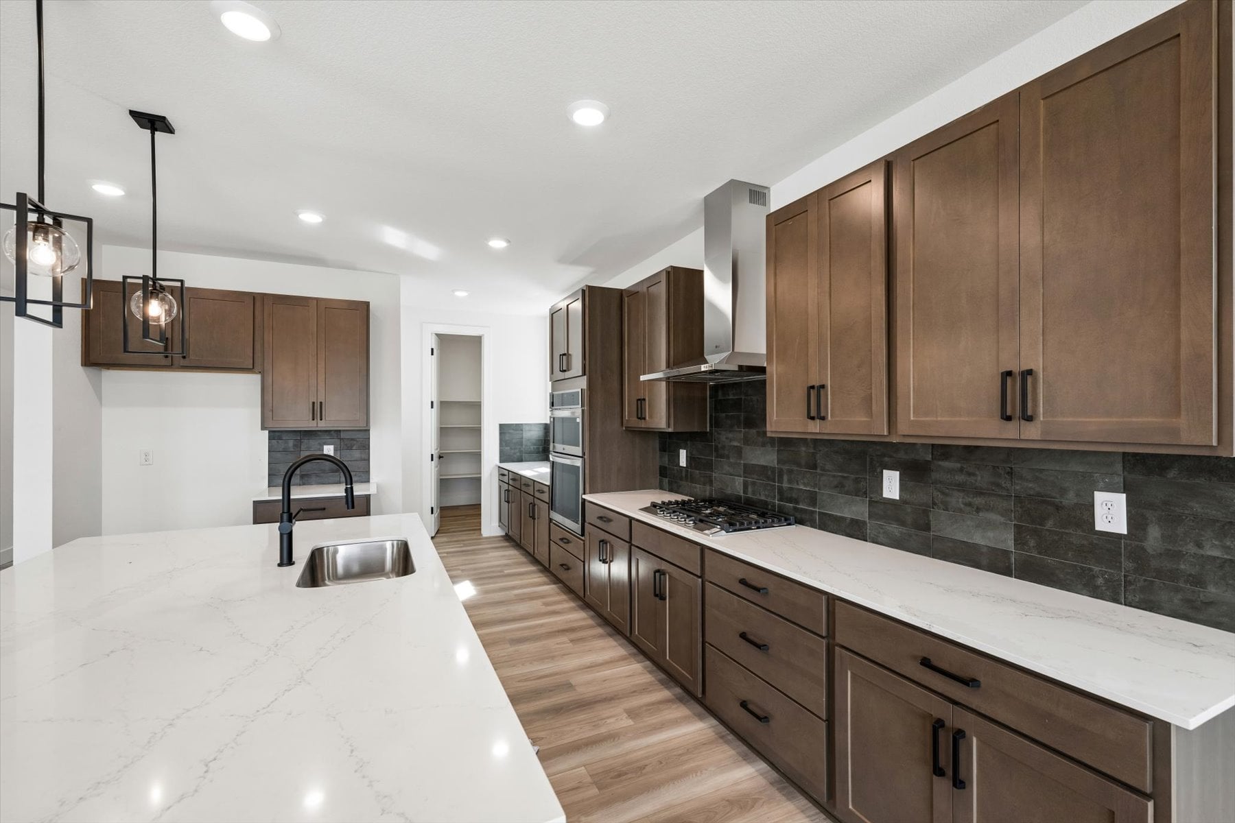 A kitchen with wooden cabinets.