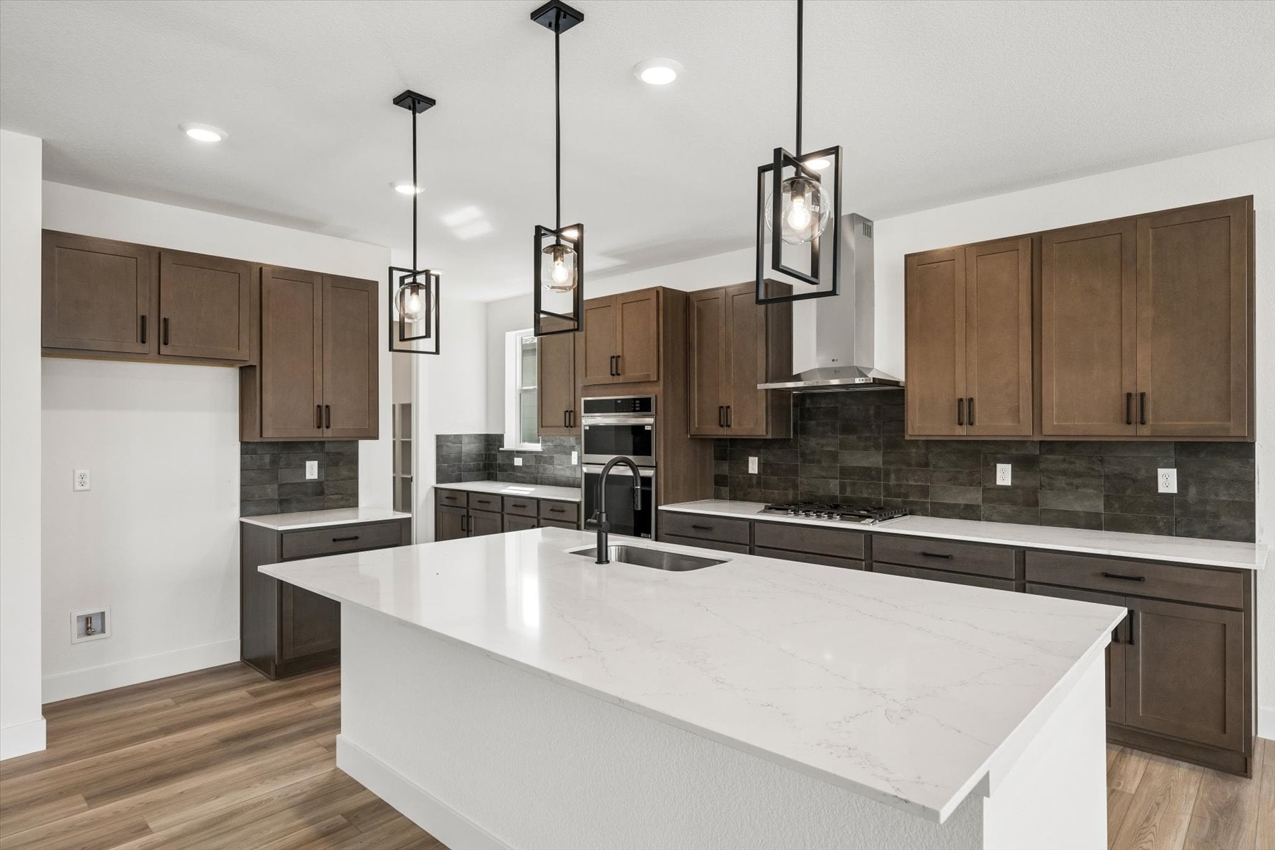A kitchen with a marble counter top.