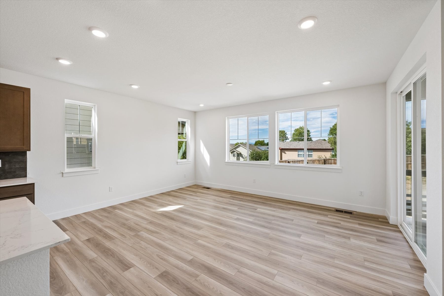 A room with a wood floor and windows.