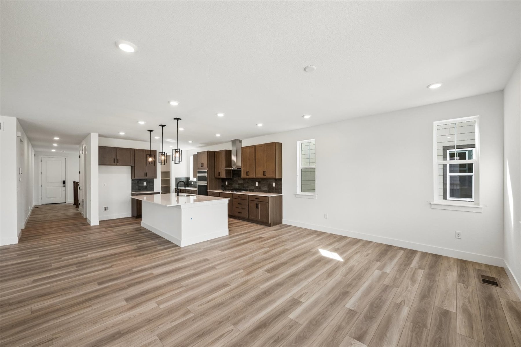 A large kitchen with wood floors.