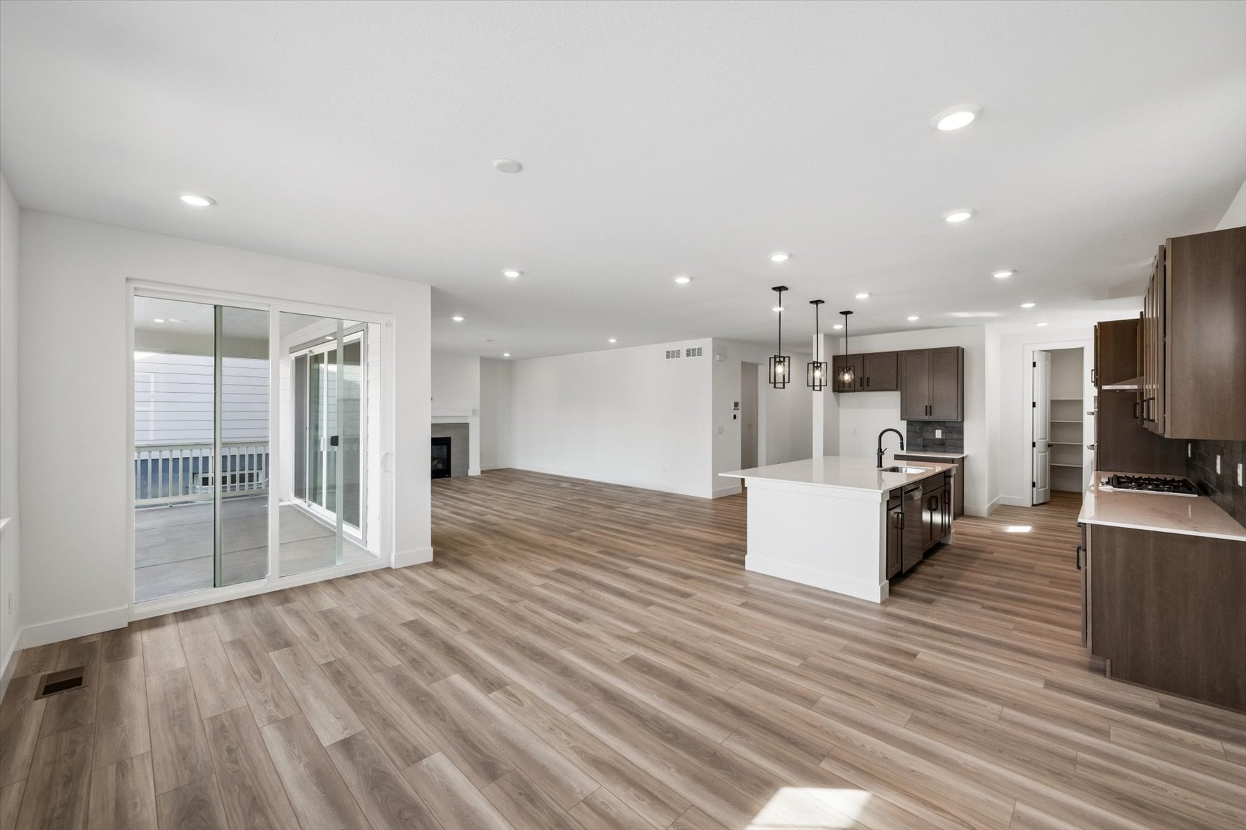 A large kitchen with a wood floor.